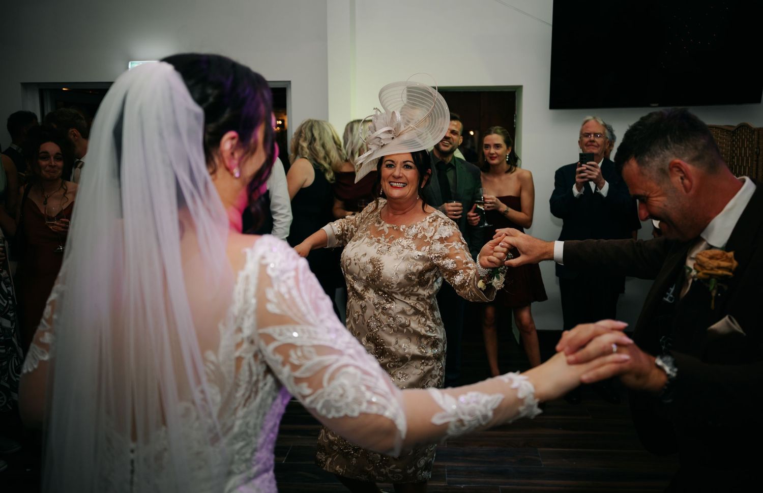 Wedding party dancing and celebrating during the evening reception.