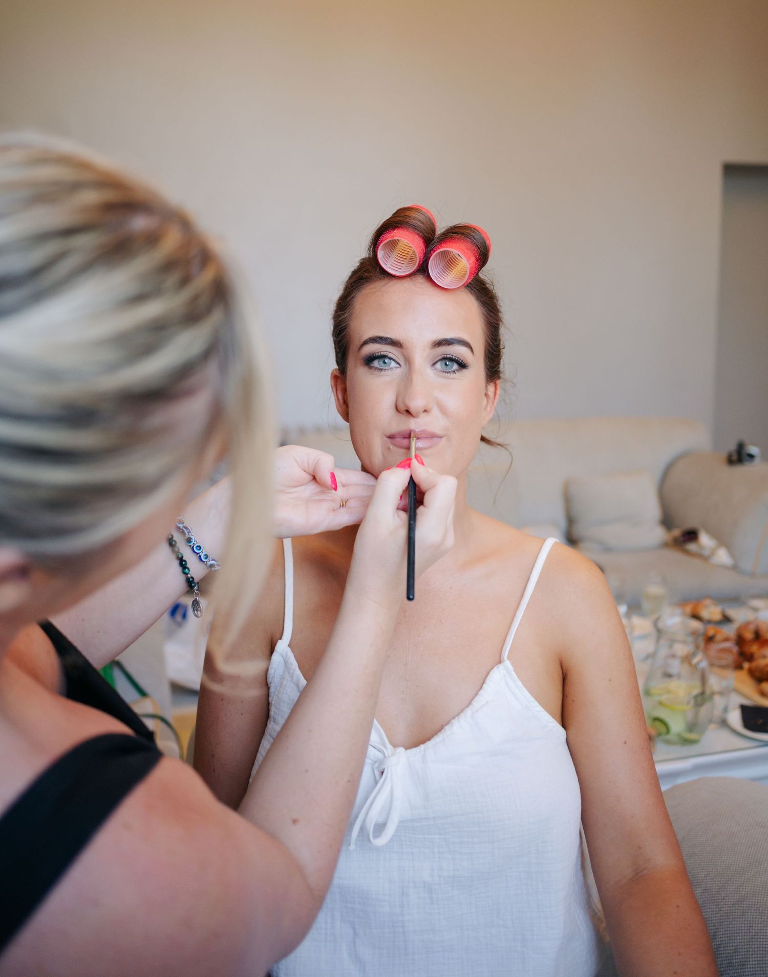 Close-up sequence of makeup being applied with brushes during wedding preparation.