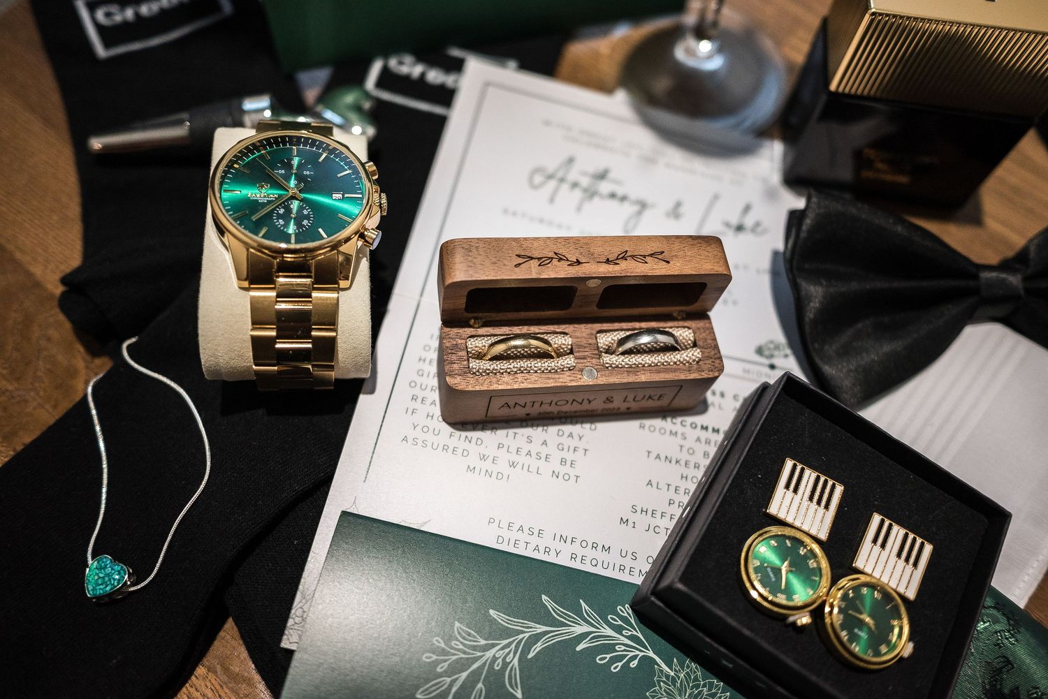 Luxury wedding accessories including gold watch, earrings and jewelry on display.