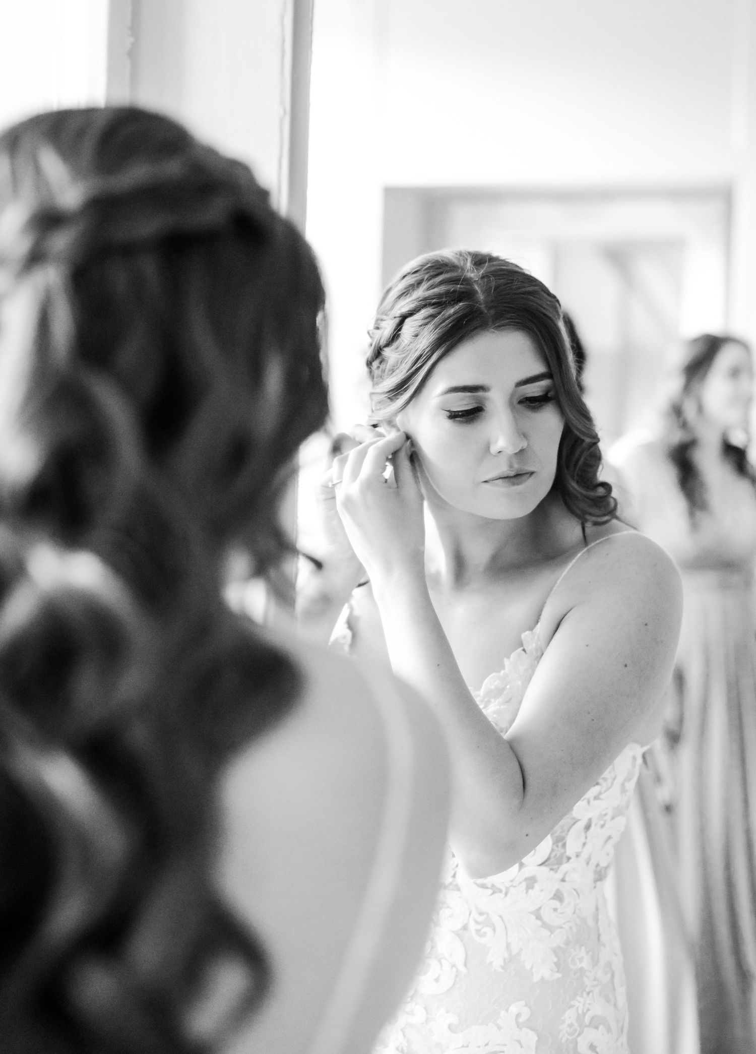 A side view shows someone in a lace dress adjusting their hair in preparation for the wedding.