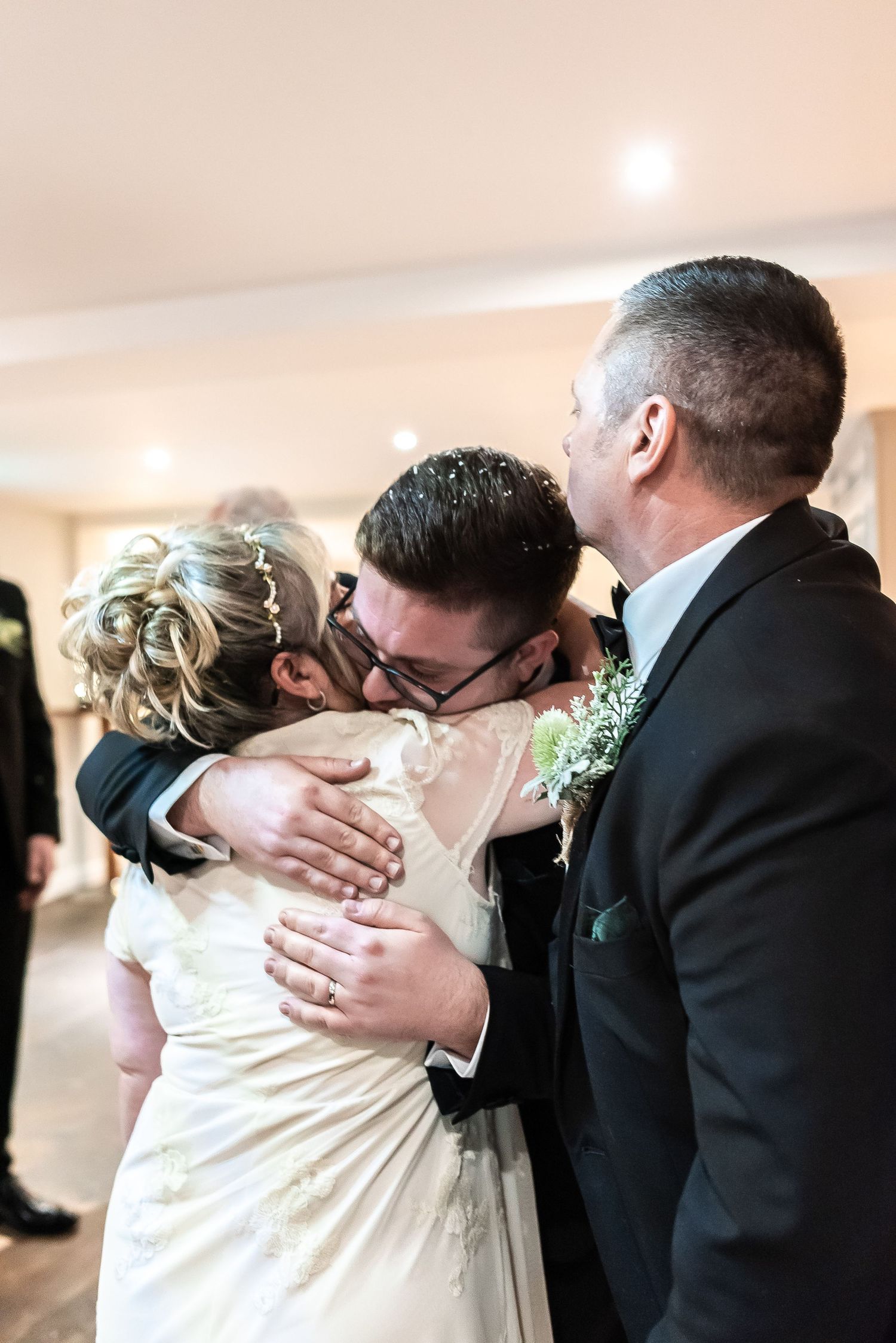 An emotional embrace shared during wedding celebration.