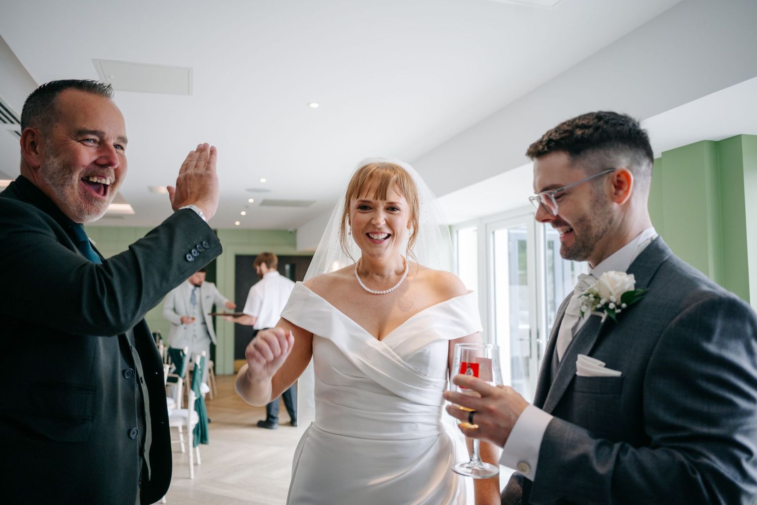 Emotional reactions during a wedding first look in a bright indoor setting.