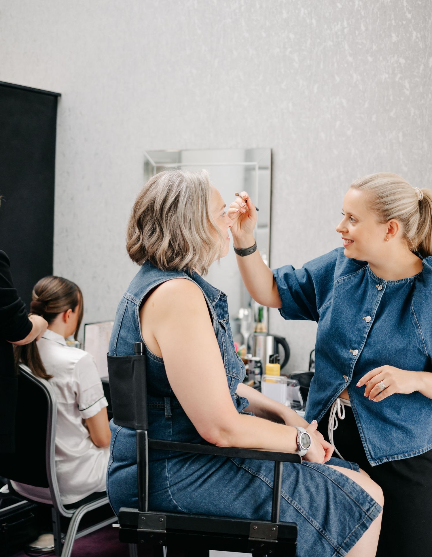 Behind the scenes preparation moments captured in a salon setting.