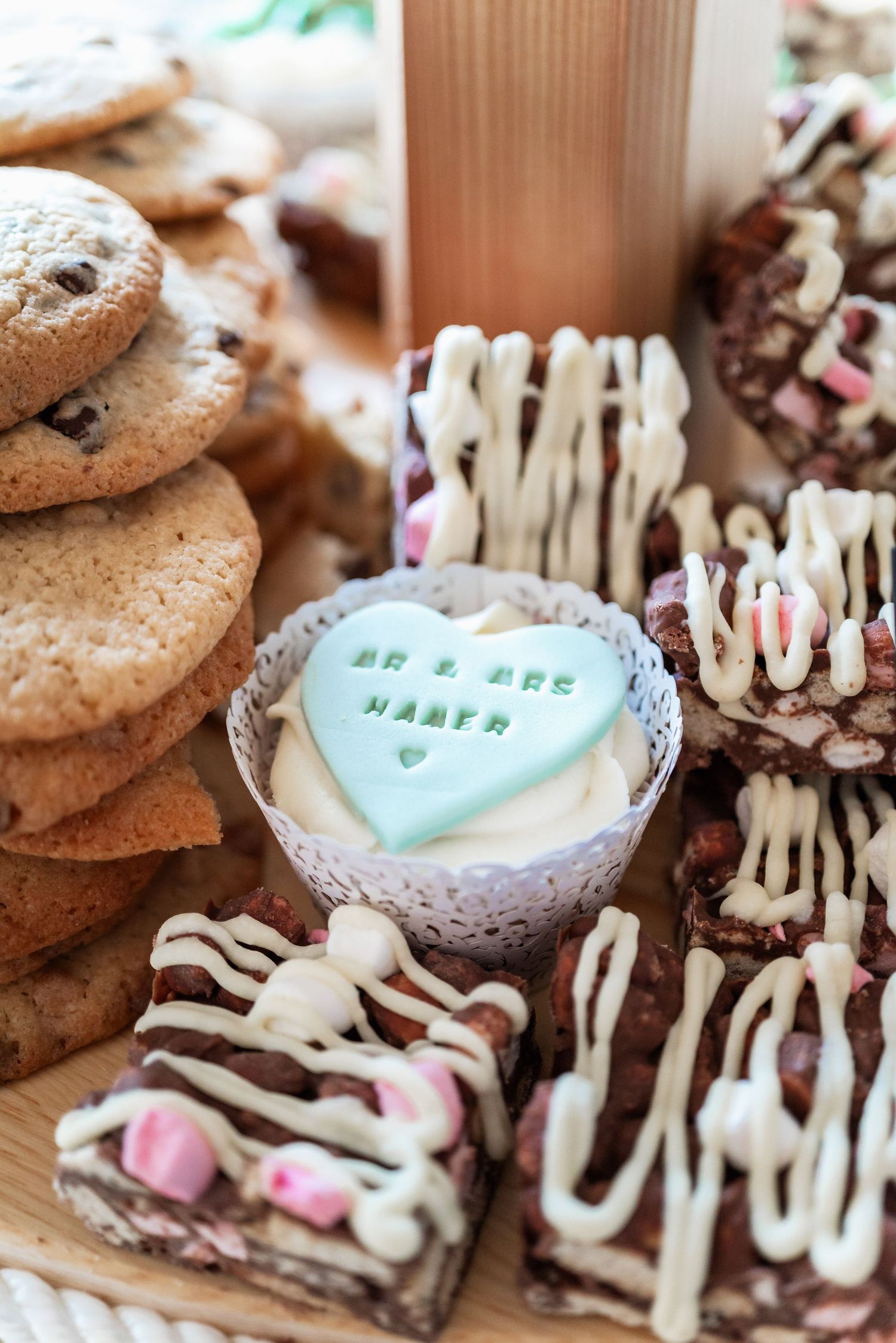 Close-up of wedding desserts including cookies, brownies and a mint green heart-shaped treat.