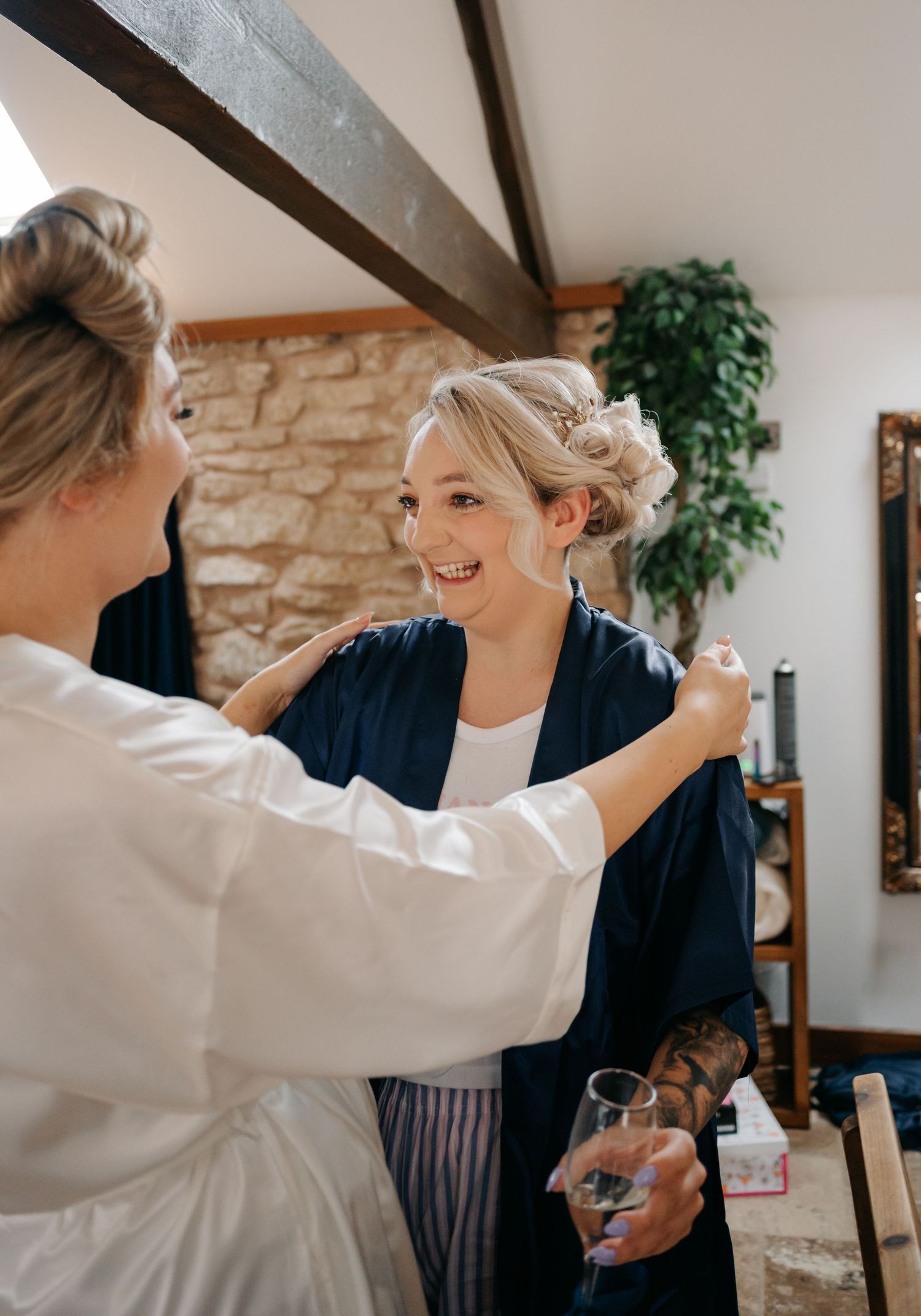 Professional stylist carefully adjusts the finishing touches while preparing for a special occasion in an elegant interior.