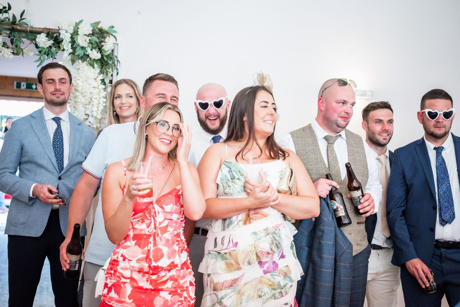 Wedding guests enjoying drinks and socializing at an outdoor reception.