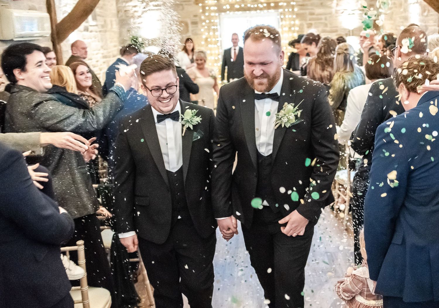 Celebration with confetti and formal attire in rustic venue setting.