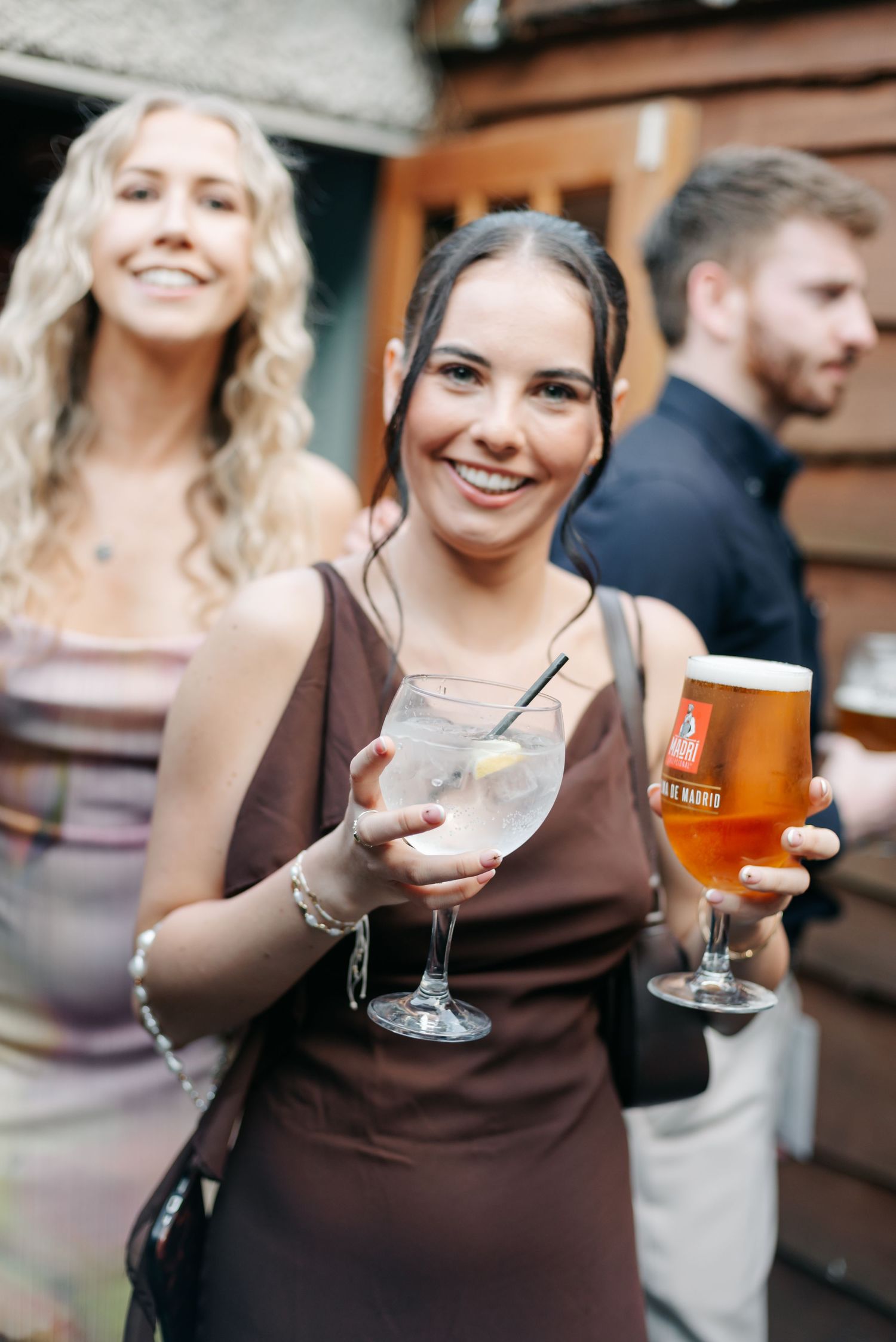 Wedding guests enjoying cocktails and beer at a celebration.