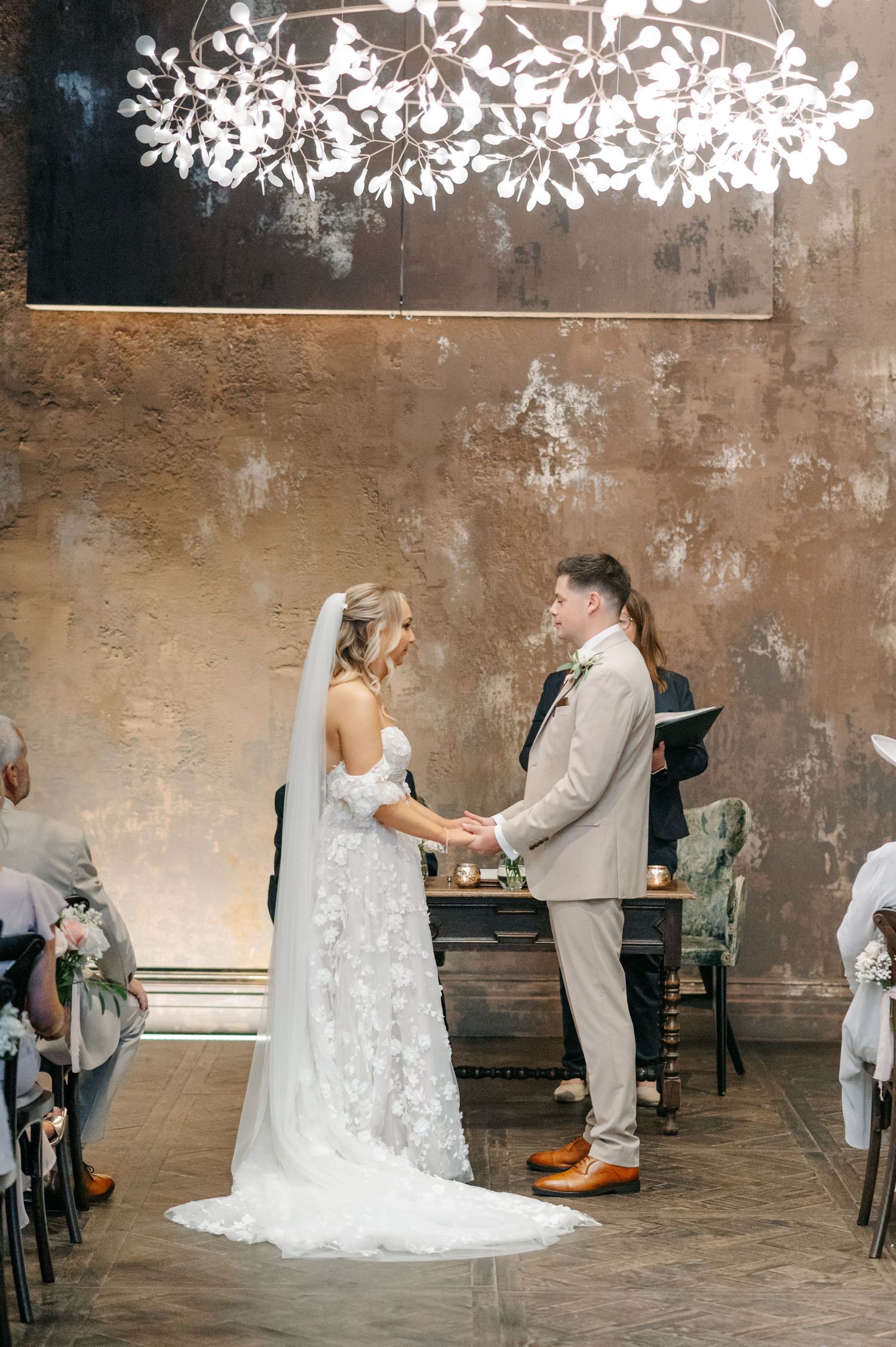 A series of wedding dance photos showing a couple twirling in a rustic venue with textured walls and floral decor.