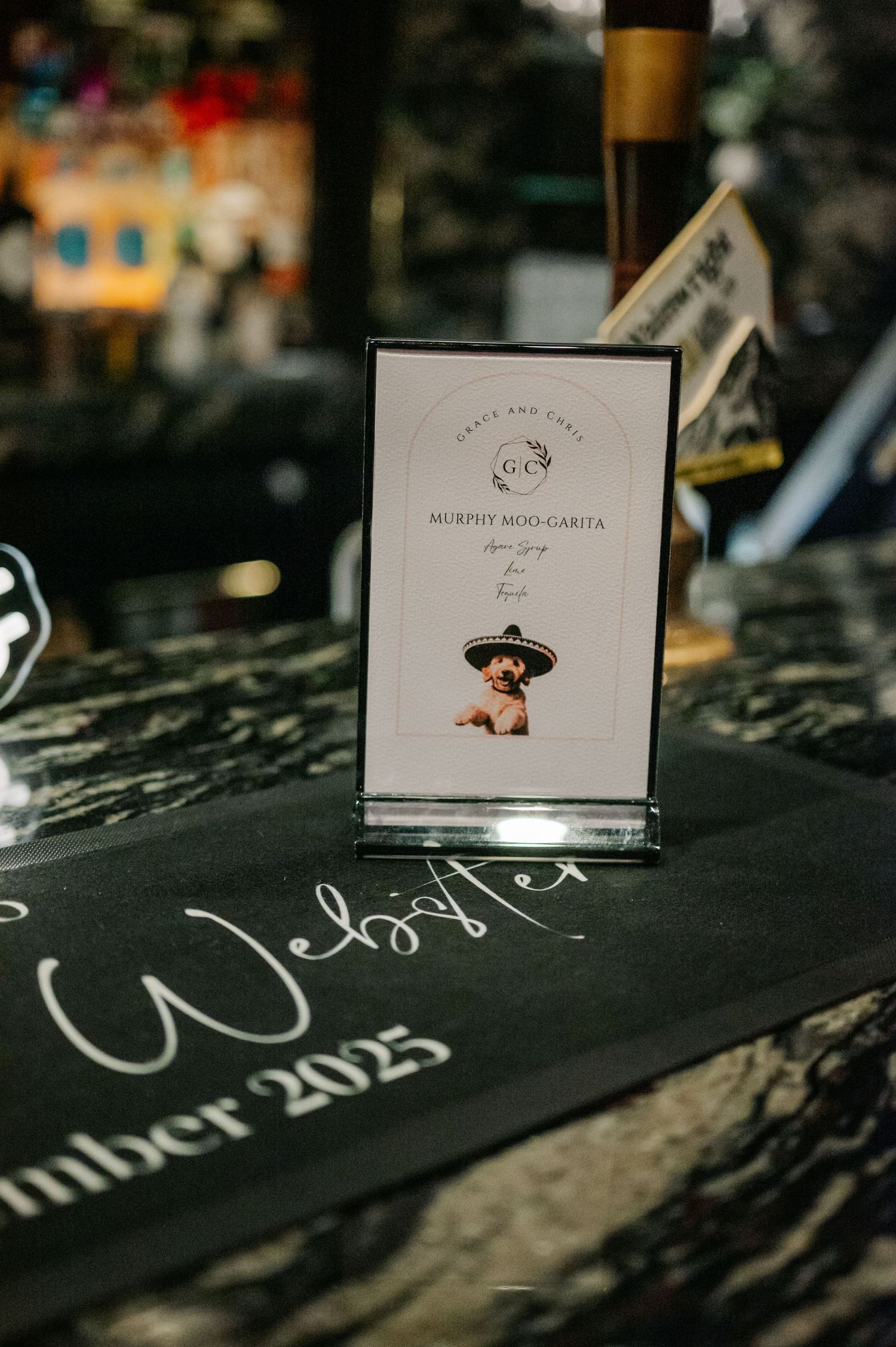 Wedding place cards displayed on a dark surface with elegant calligraphy details.