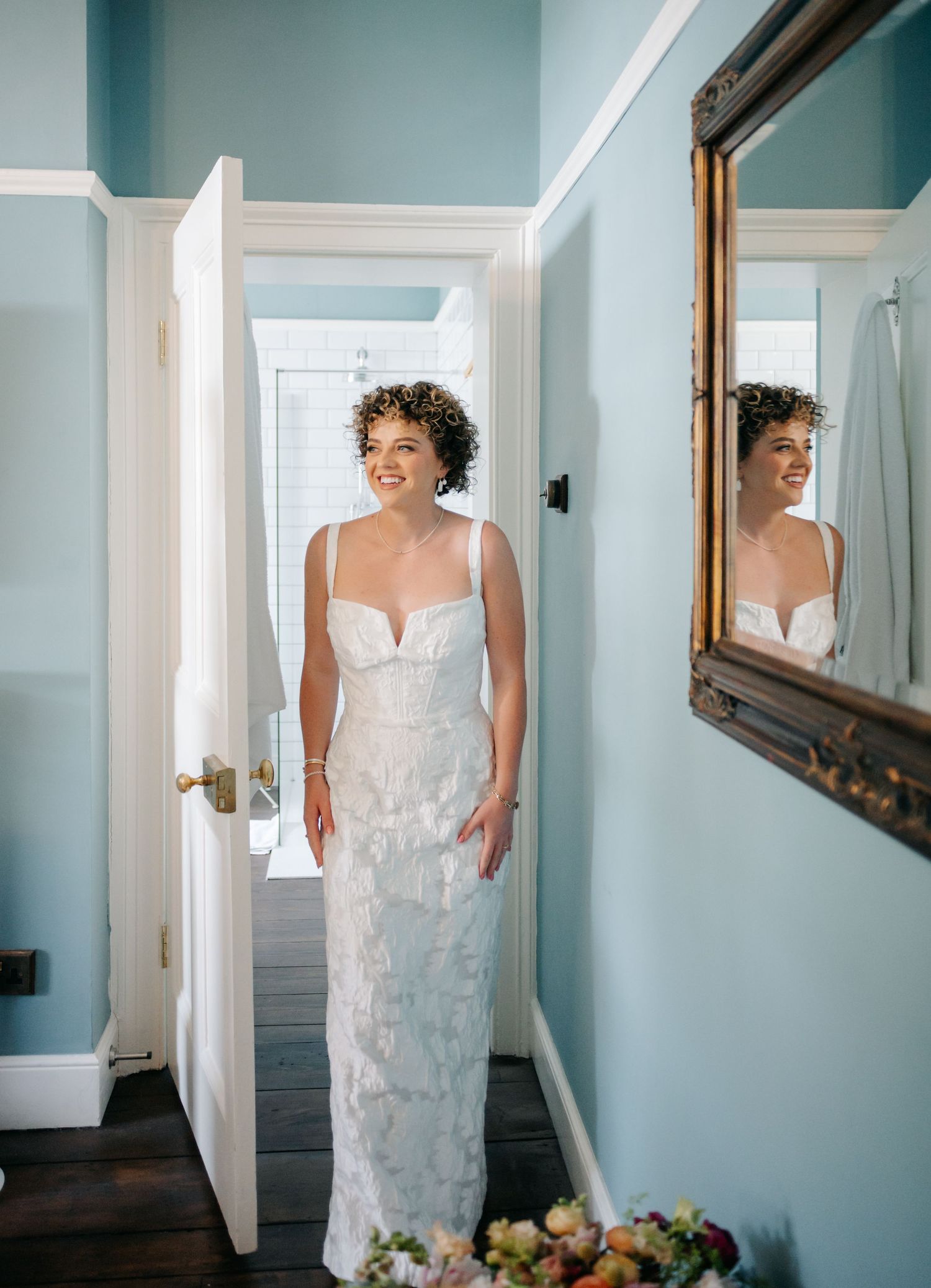 A series of photos showing a bride in a white wedding dress getting ready in a room with blue walls.