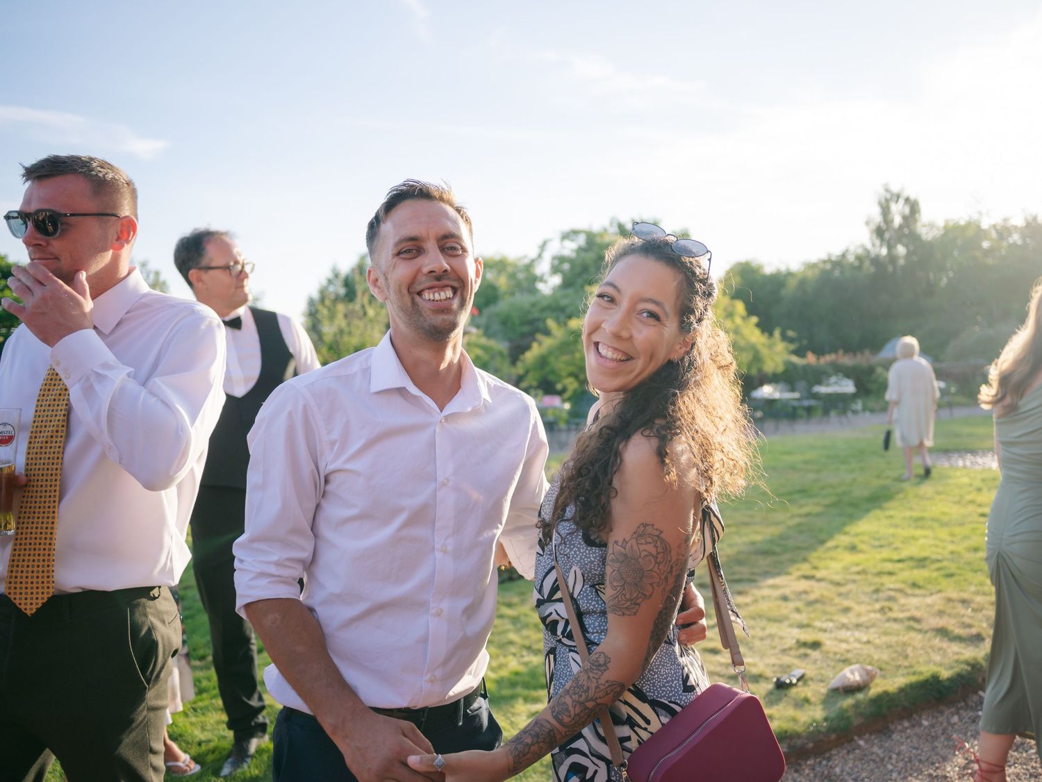 Wedding guests enjoying an outdoor celebration during golden hour.