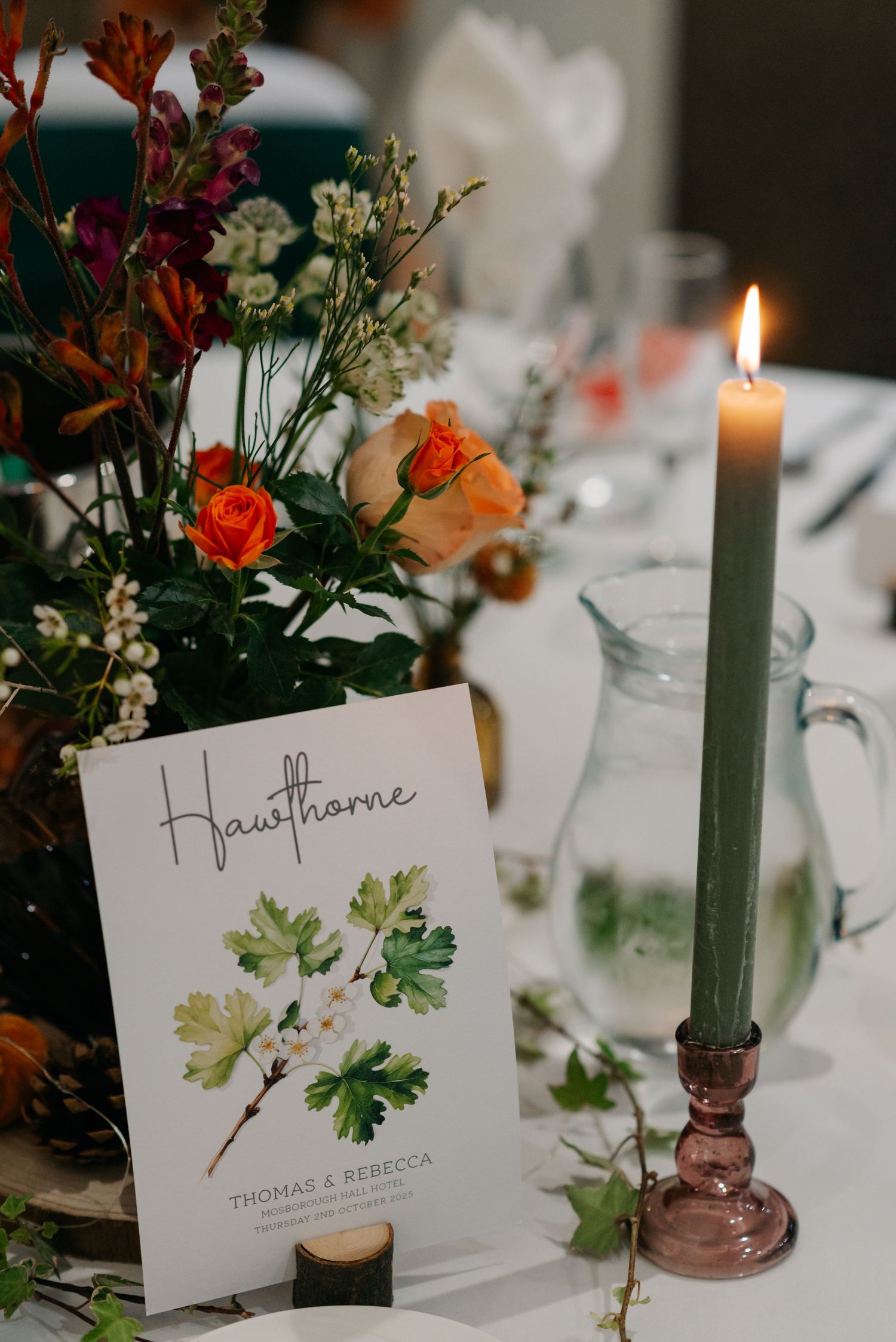 Romantic table setting with taper candles, floral centerpieces and watercolor place cards.