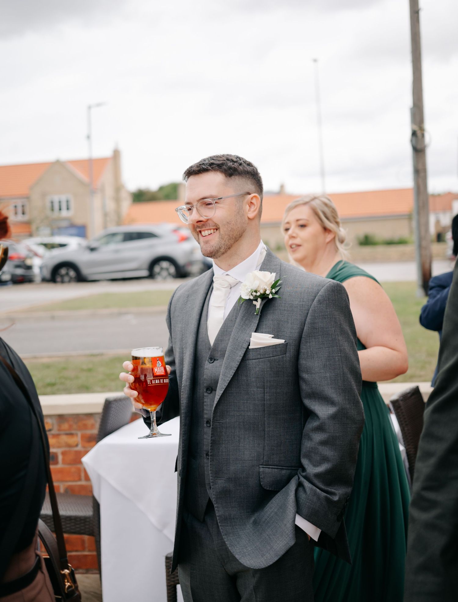 Wedding guests enjoying drinks and conversation at an outdoor reception.