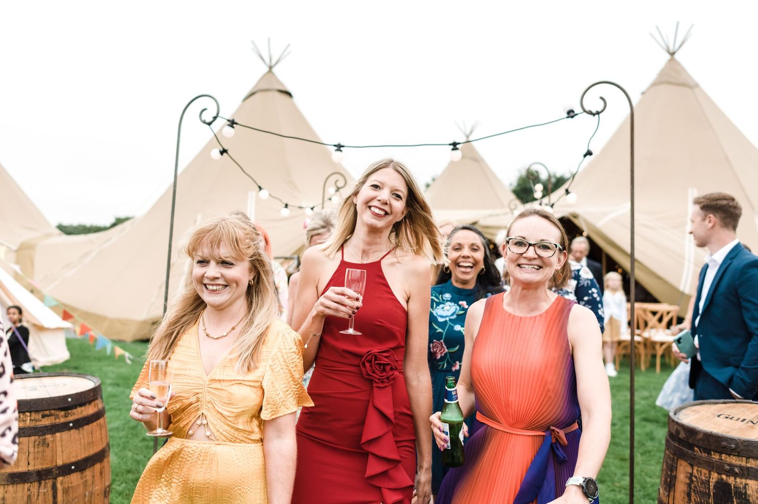Young guest peeking out from large canvas tent at outdoor wedding venue.