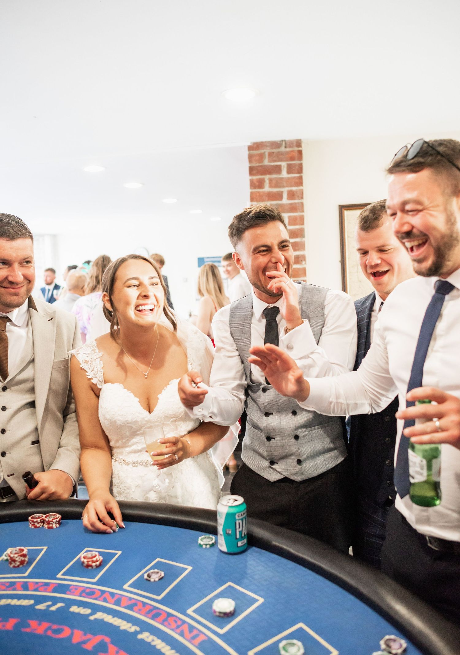 Wedding party enjoying a fun moment at a casino roulette table.