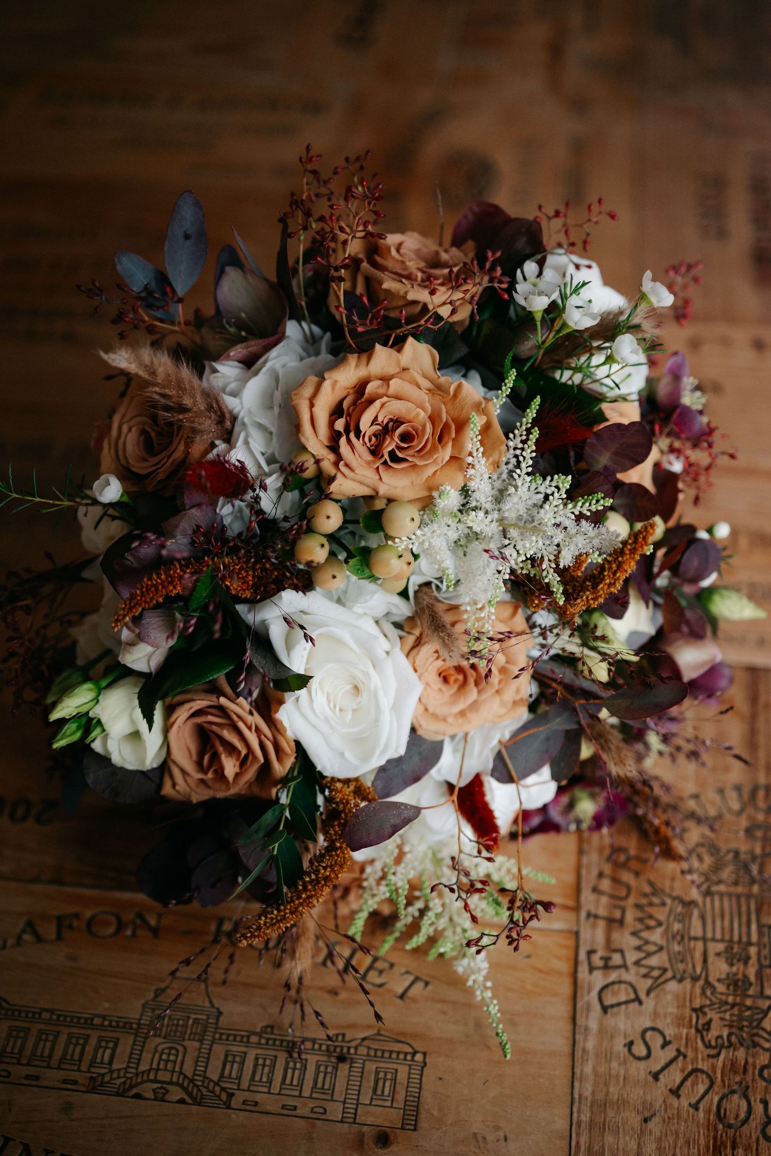 Beautiful floral arrangement with peach roses and white flowers displayed on vintage sheet music.