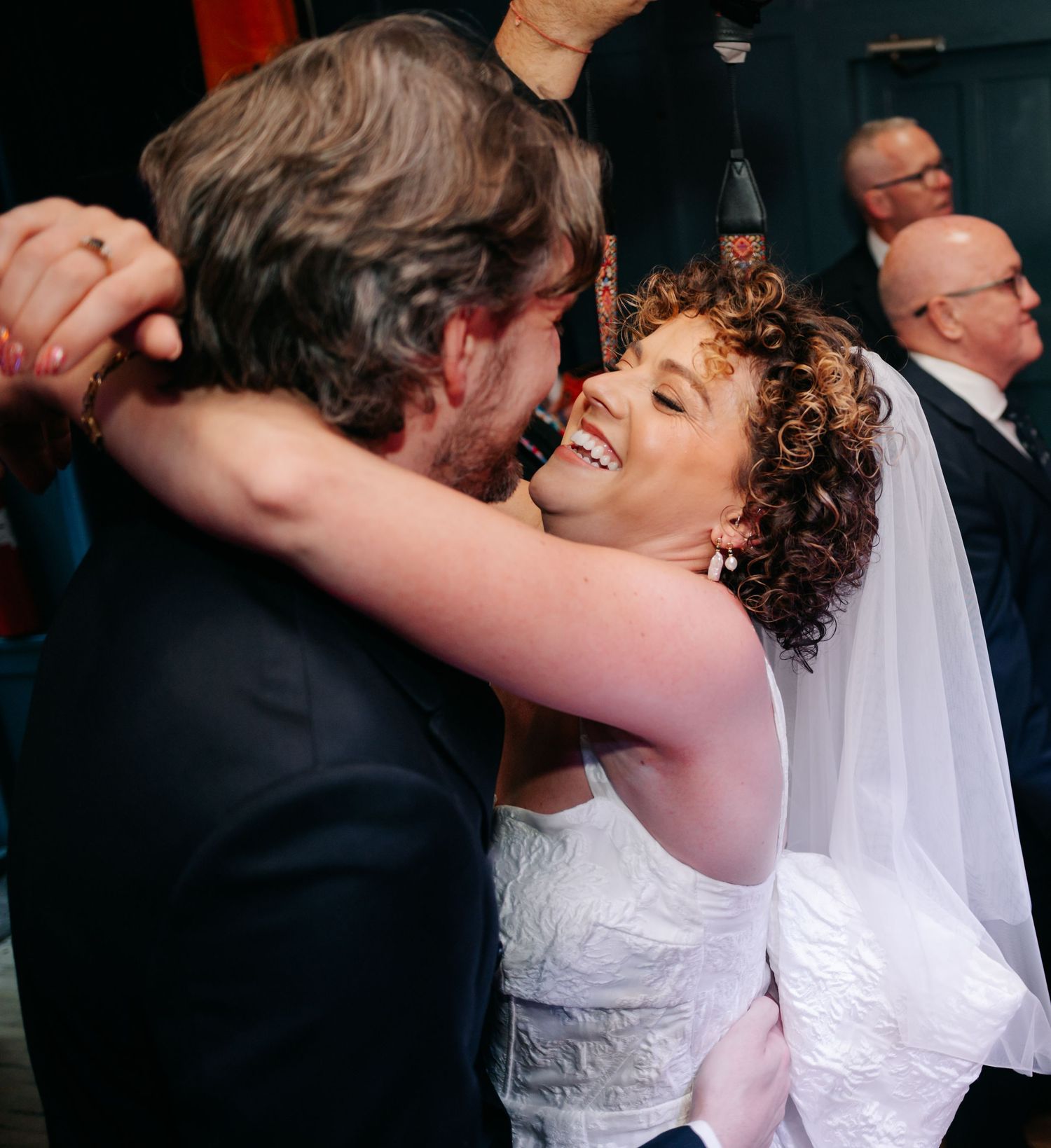 A couple shares an intimate dance moment at their wedding celebration.
