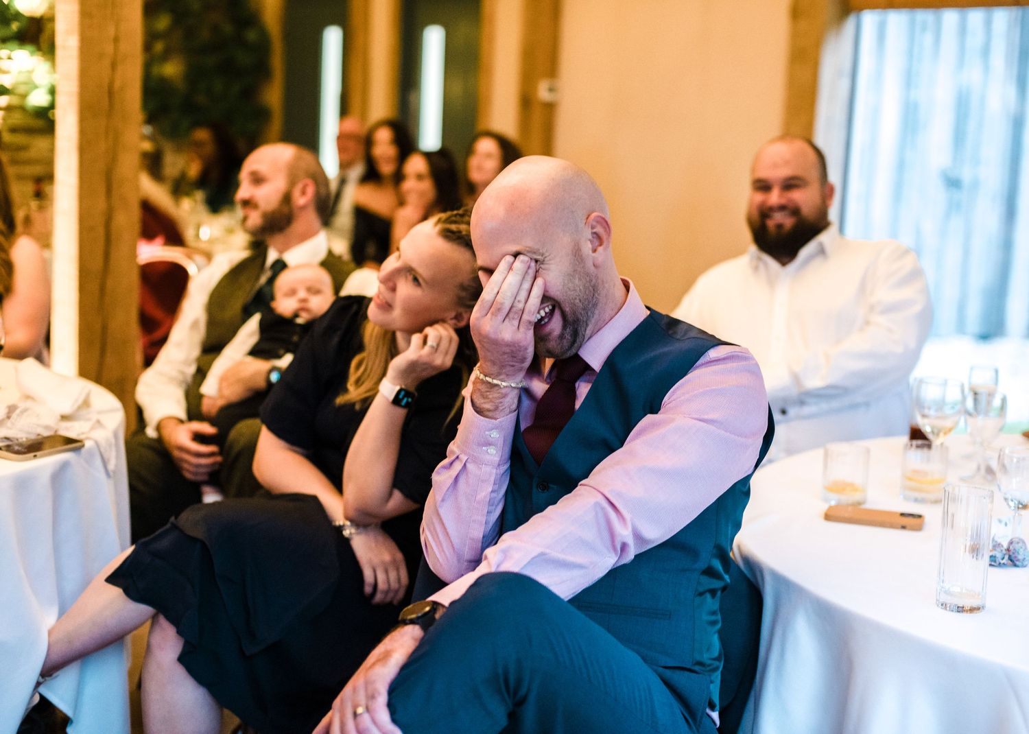 Wedding guests react emotionally during heartfelt reception speech.
