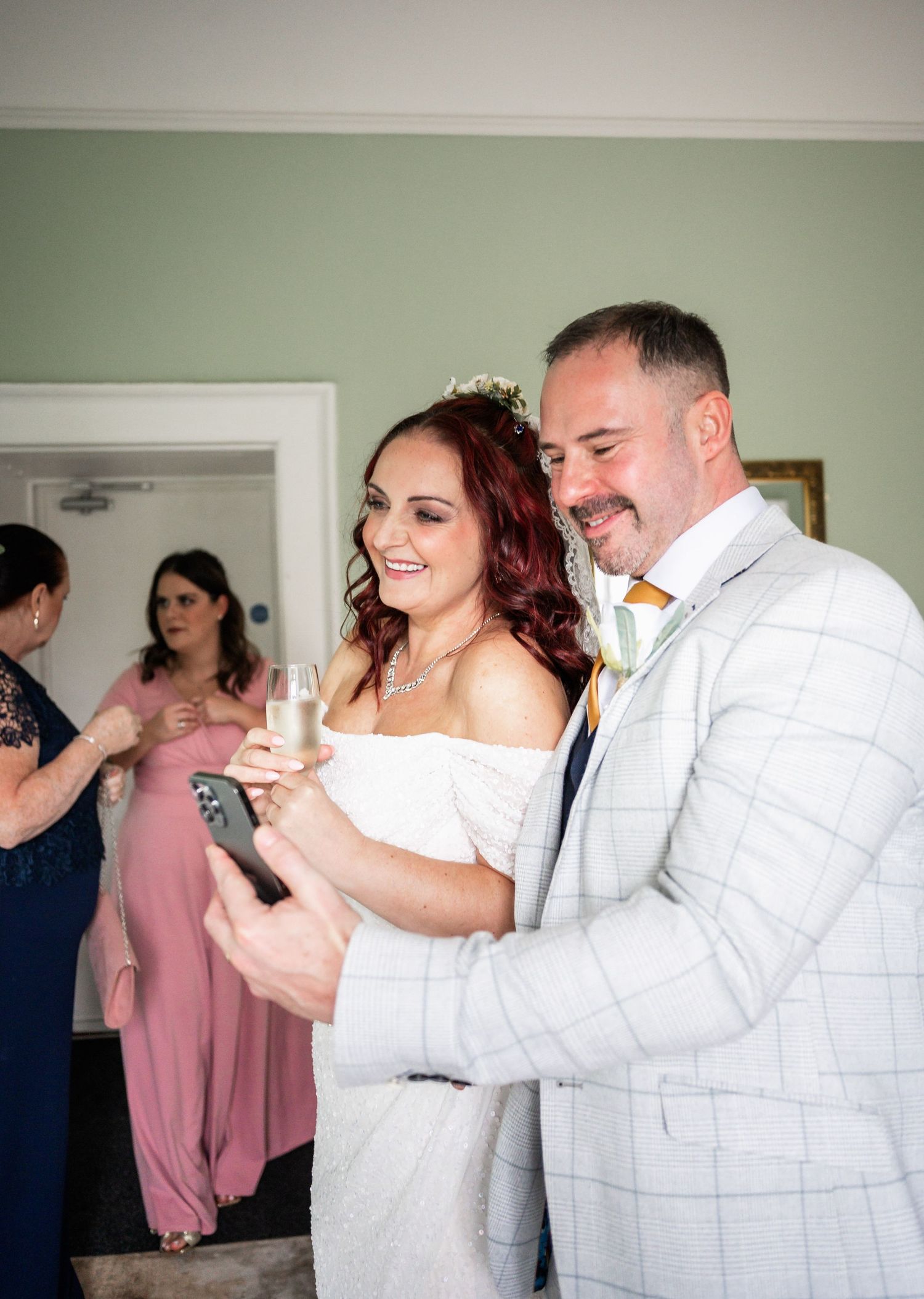 Wedding celebration moment with guests toasting and sharing champagne.