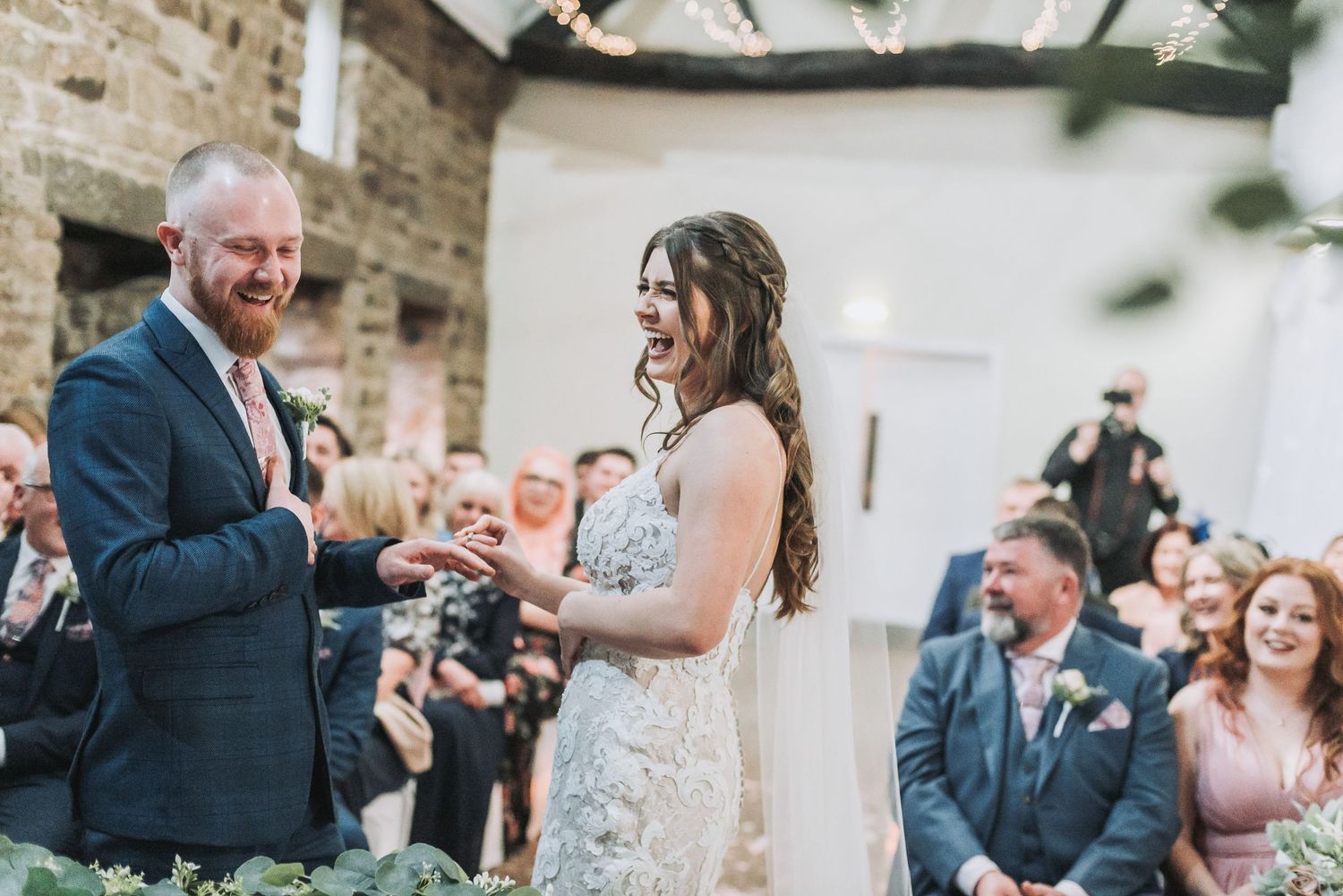 A celebratory toast moment during an outdoor wedding ceremony.