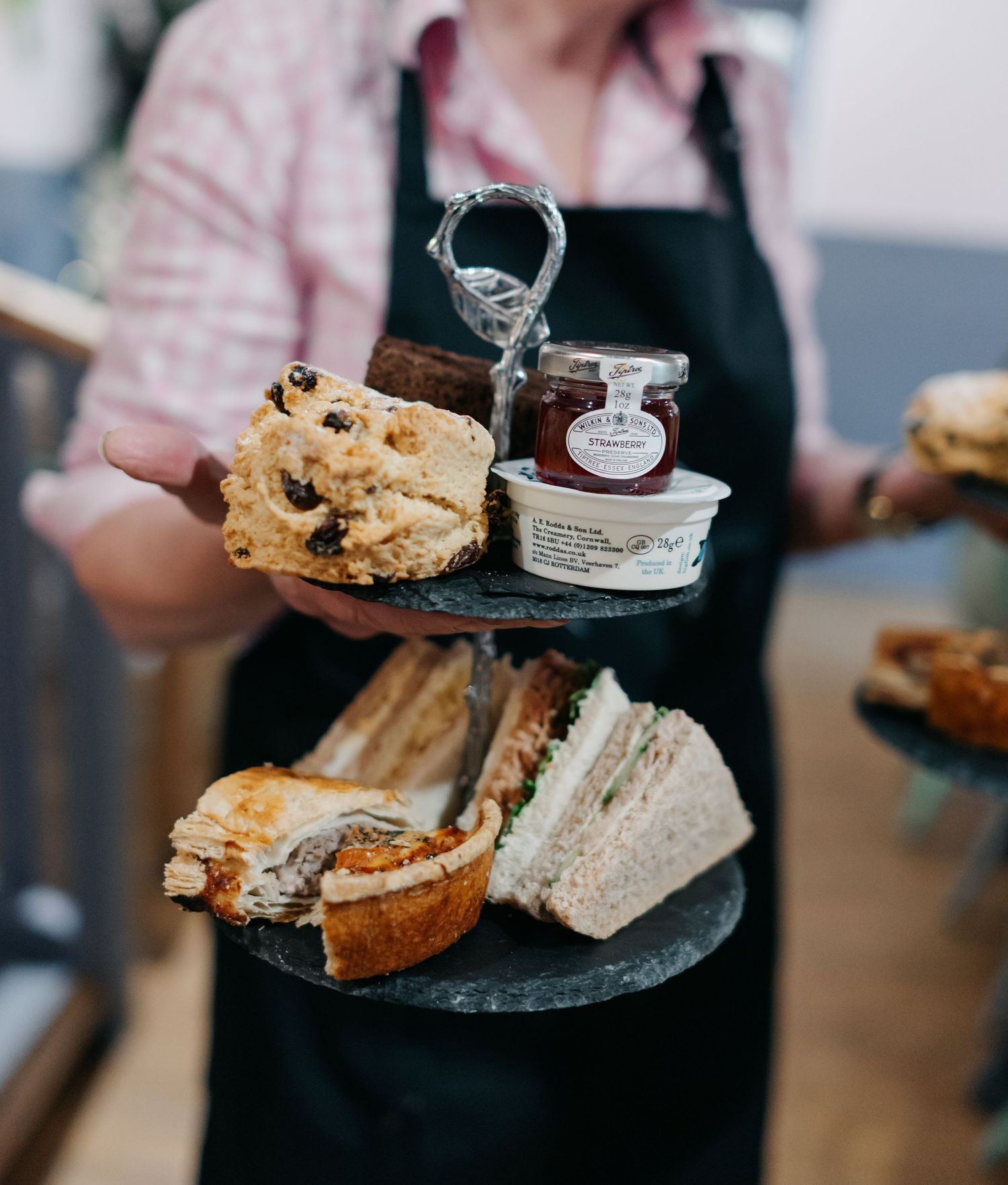 Artisanal sandwiches and treats displayed on slate serving boards at wedding reception.