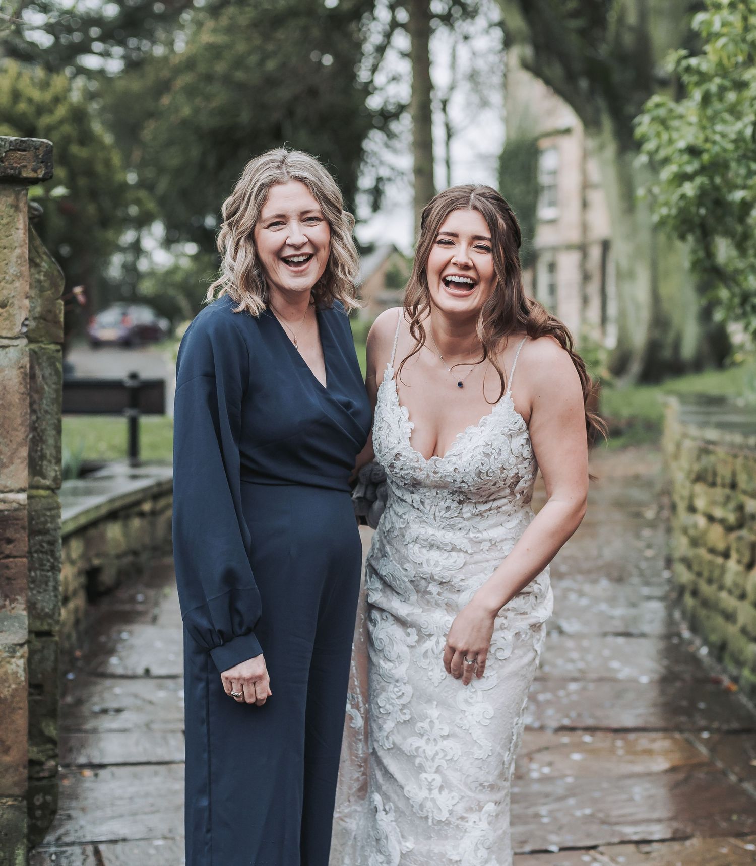 A heartwarming moment captured outdoors on a rainy wedding day.