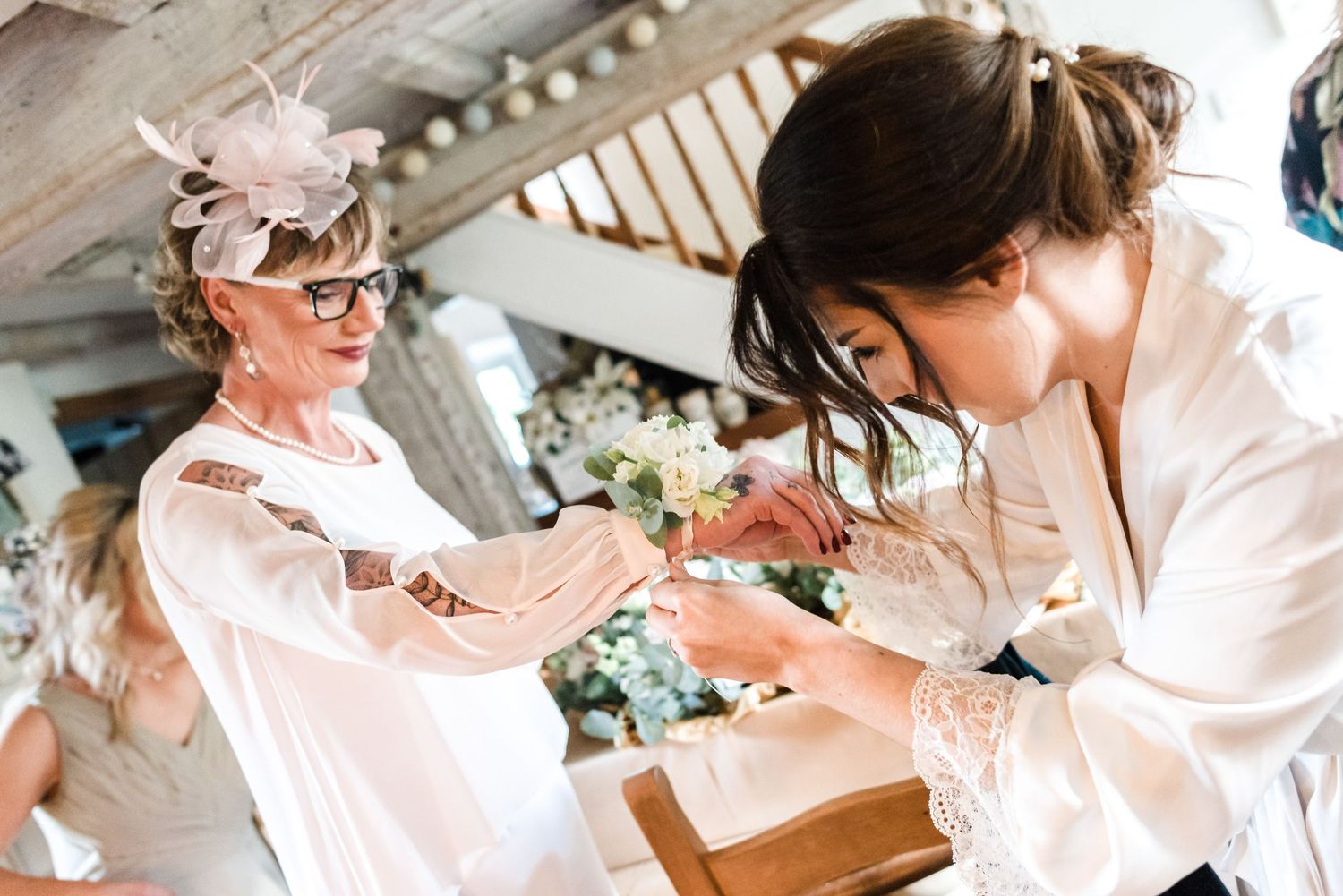 Wedding day preparations with guests getting ready in white robes.