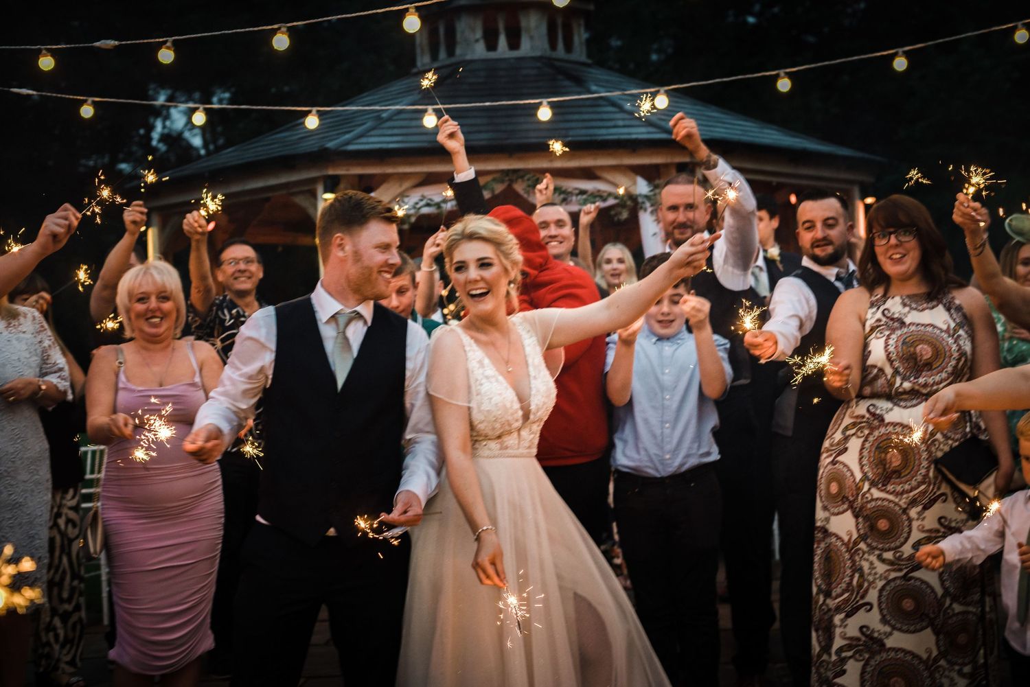Wedding celebration with sparklers creating a magical nighttime atmosphere.