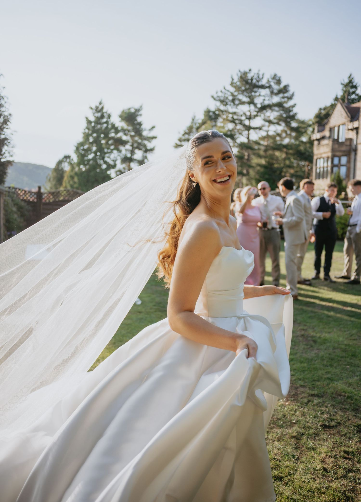 White wedding dress billowing dramatically in the outdoor breeze.