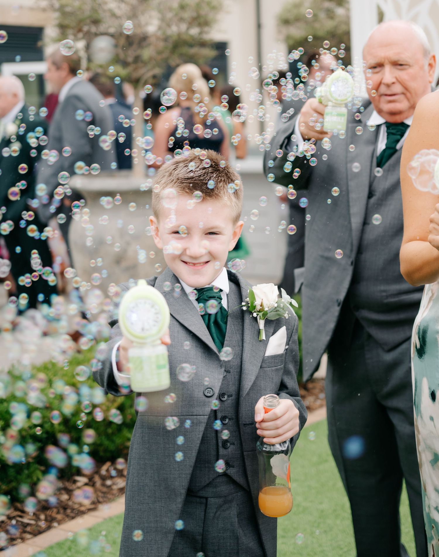 Bubbles floating through the air at an outdoor wedding celebration.