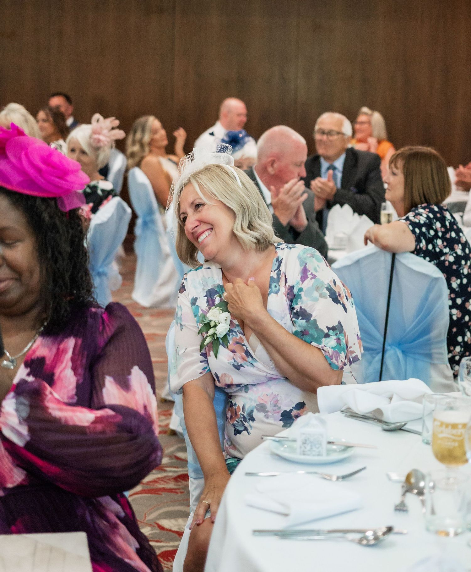 Wedding guests enjoying themselves at a reception with colorful attire and festive atmosphere.