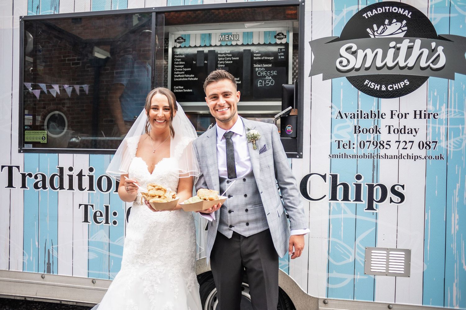 Couple getting traditional fish and chips from Smith's food truck at their wedding.