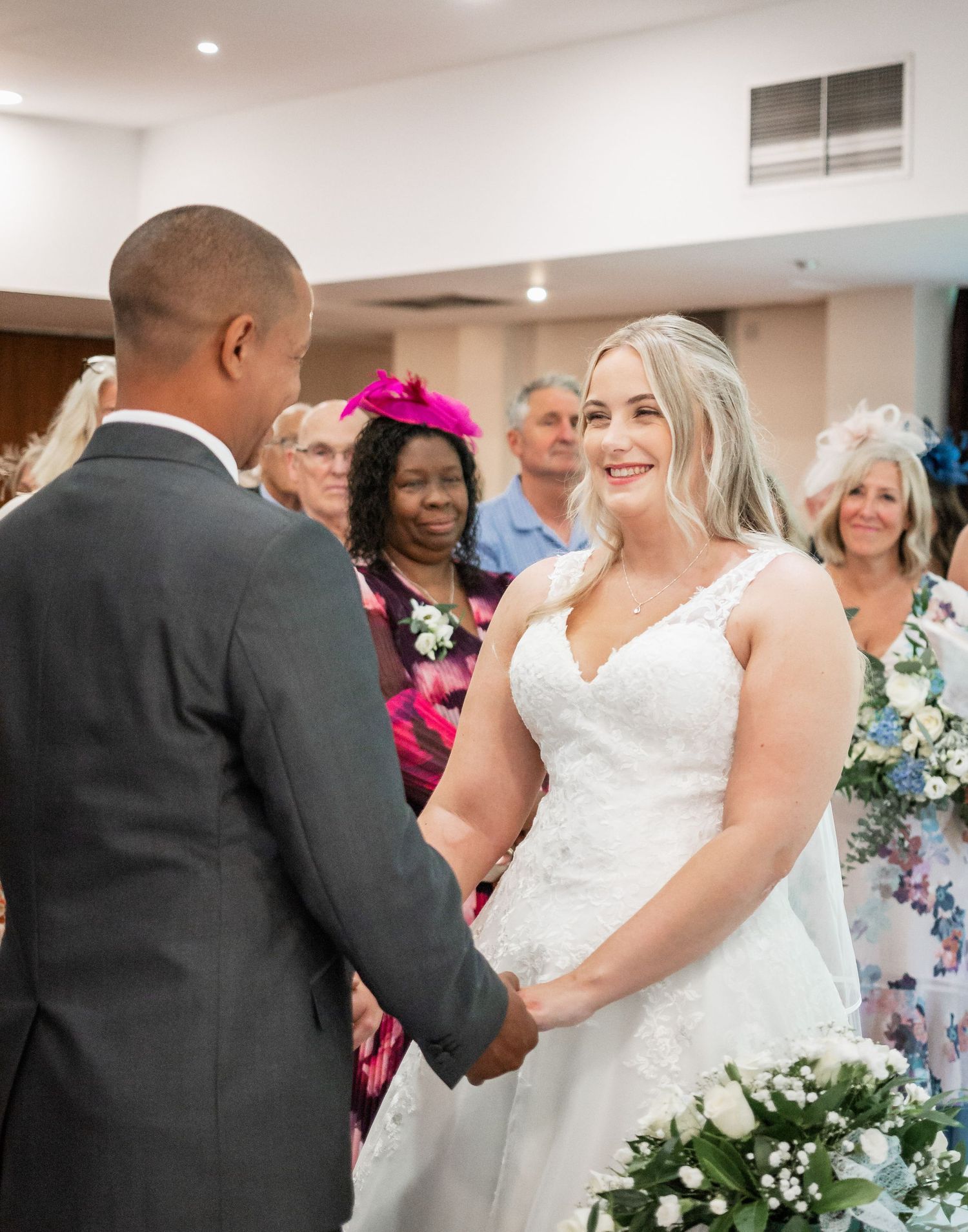 An intimate wedding ceremony moment in front of gathered guests.