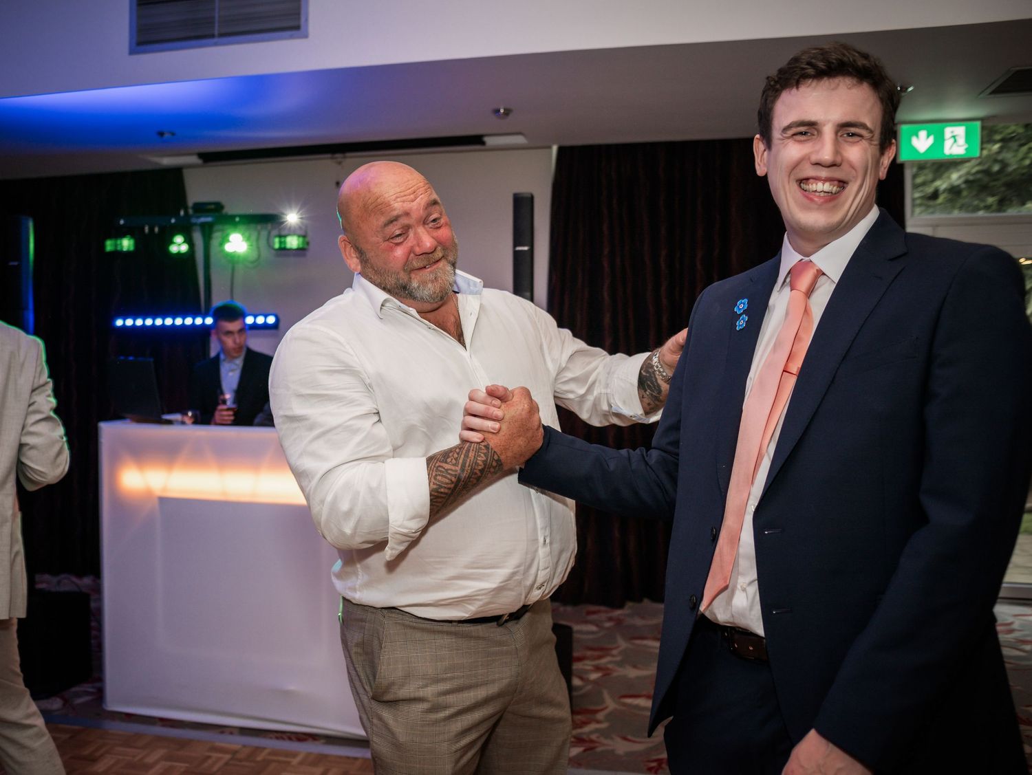 Reception guests share lighthearted moment on dance floor.