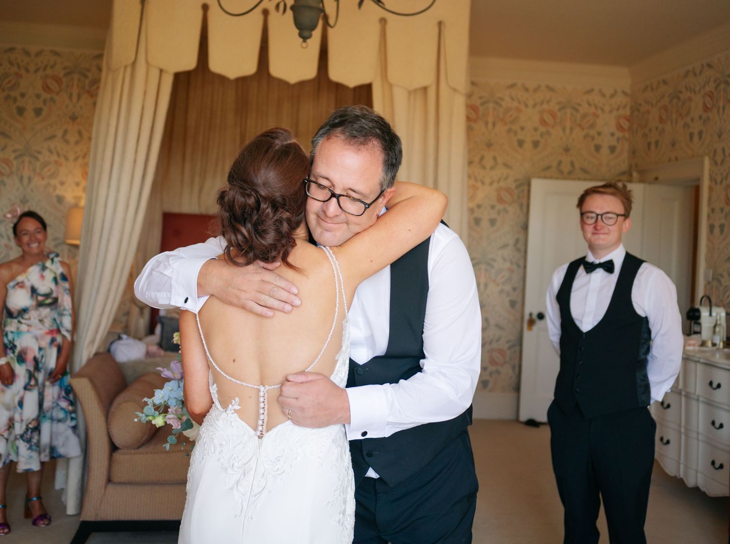 A series of emotional moments captured during a wedding reception showing embraces and celebrations in an elegant ballroom.