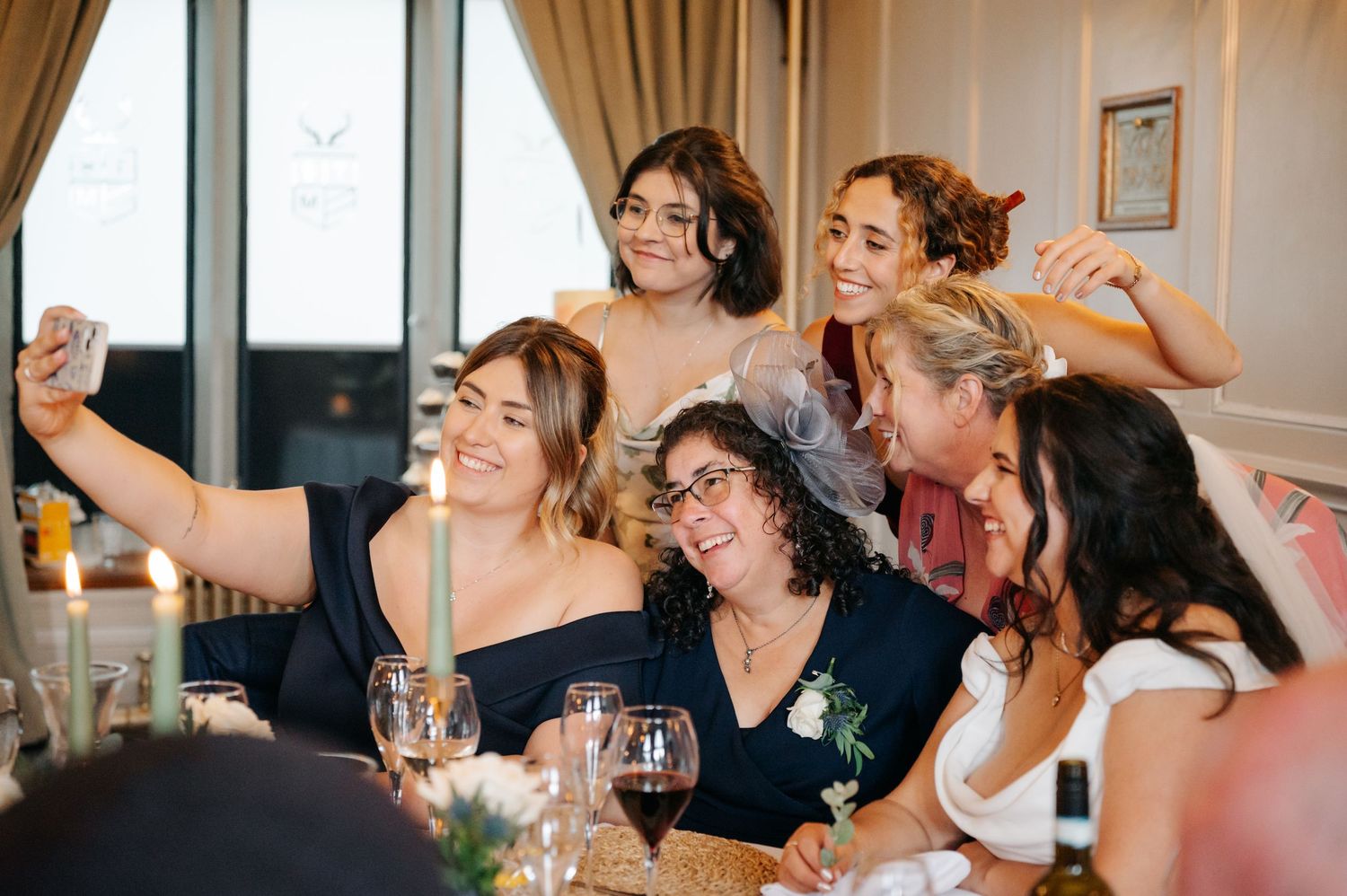 Wedding reception guests enjoying themselves at tables with navy blue decor.