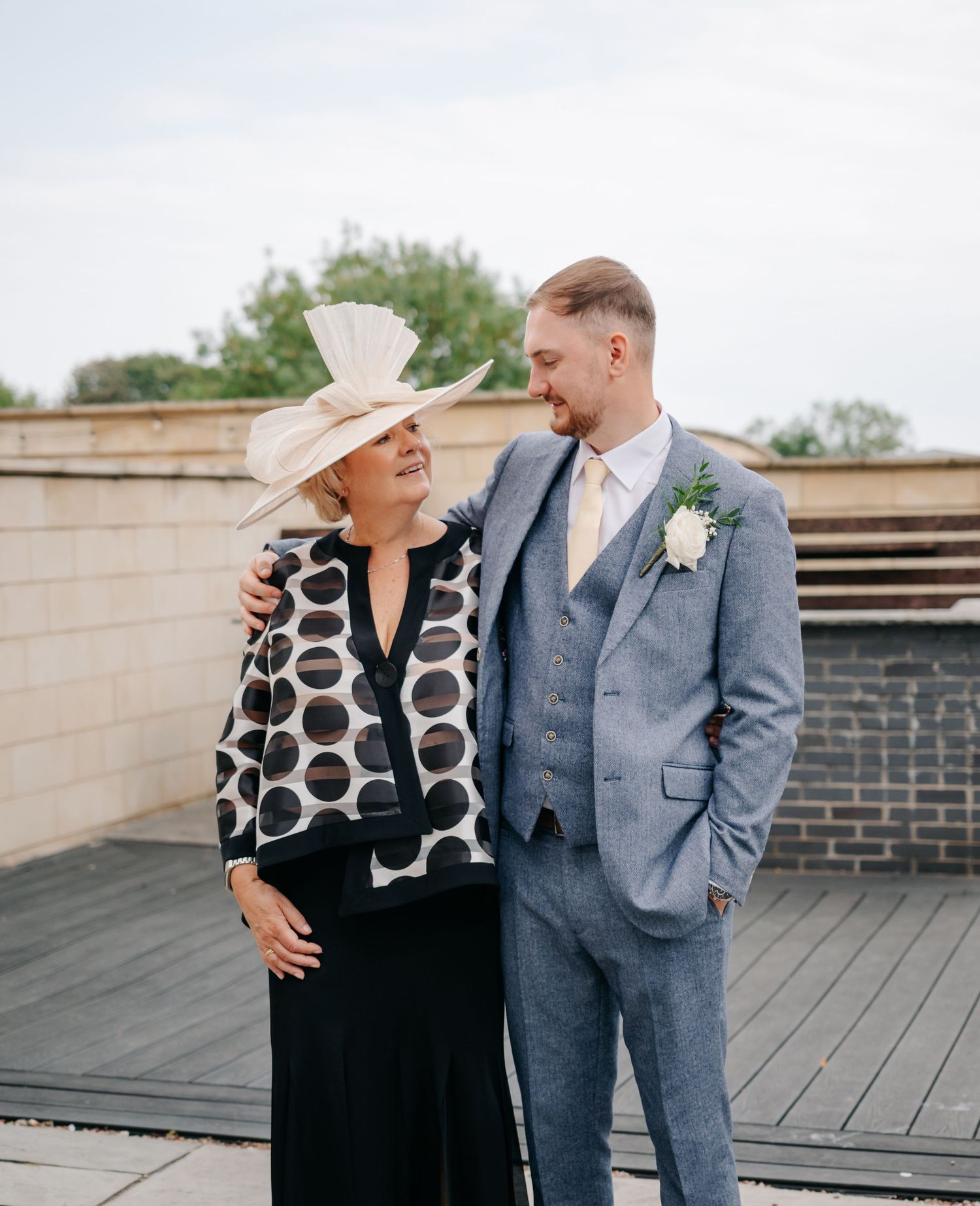 Joyful moments shared on wooden deck during wedding celebration.