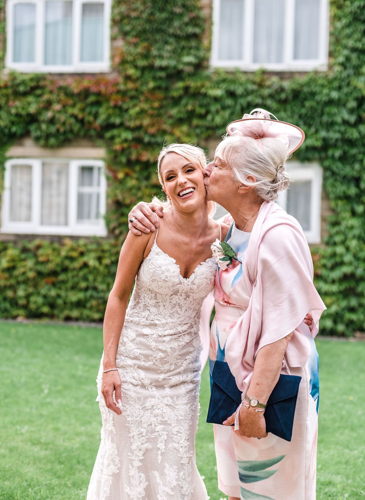 A touching emotional moment outdoors with the bride in a lace wedding dress.