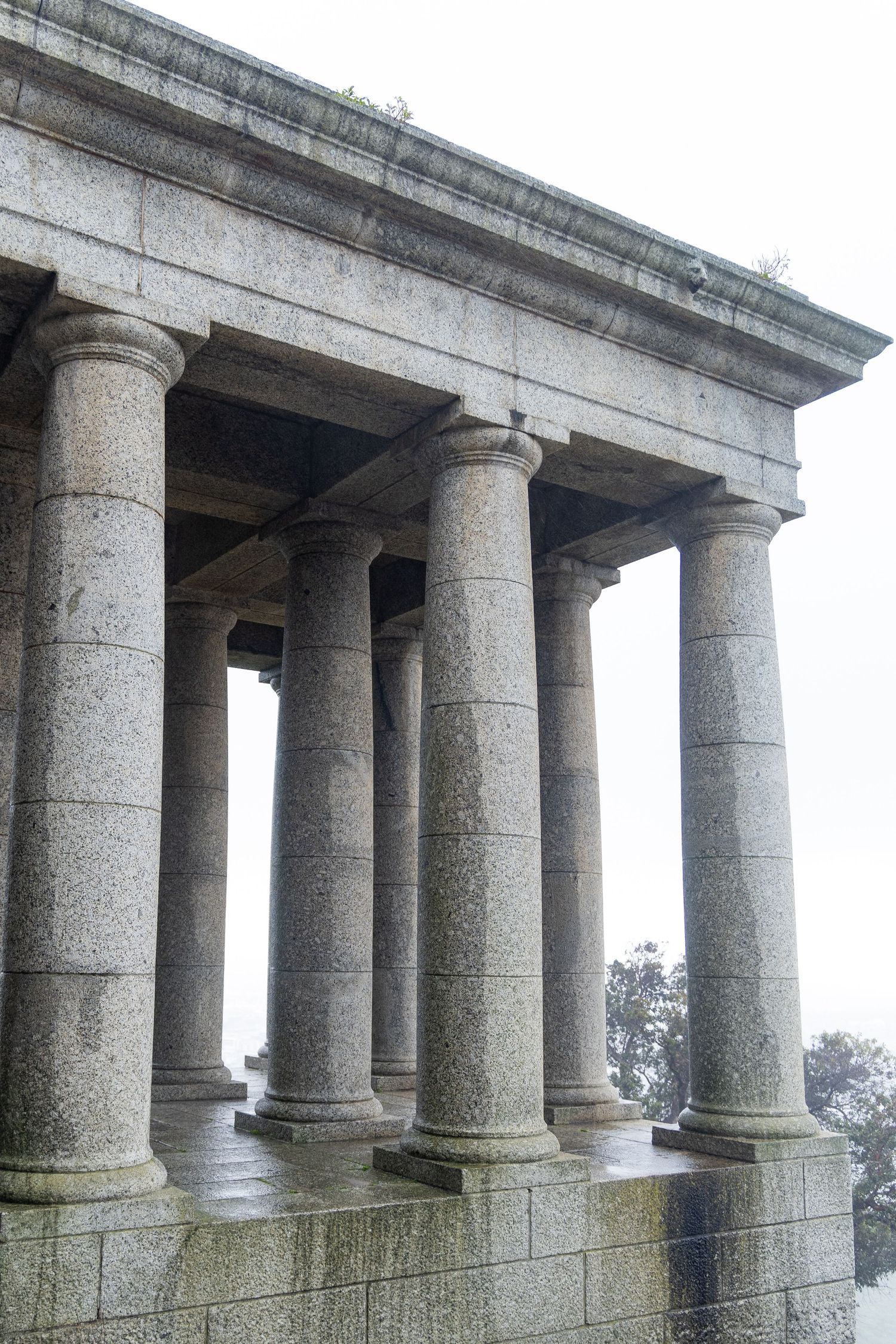 Row of majestic stone columns and architectural details of a classical building.