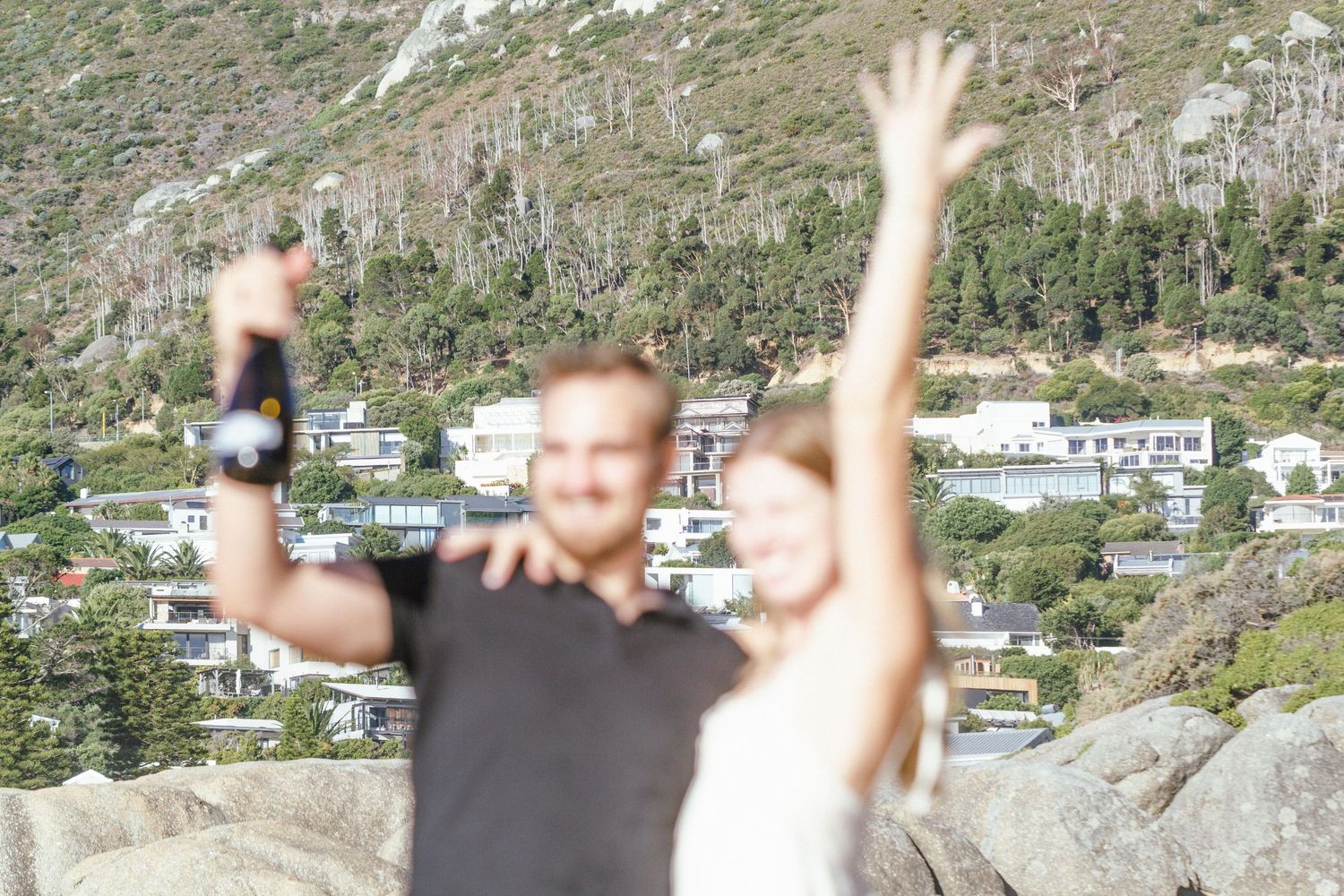 Blurred celebratory moment captured against mountainous backdrop.