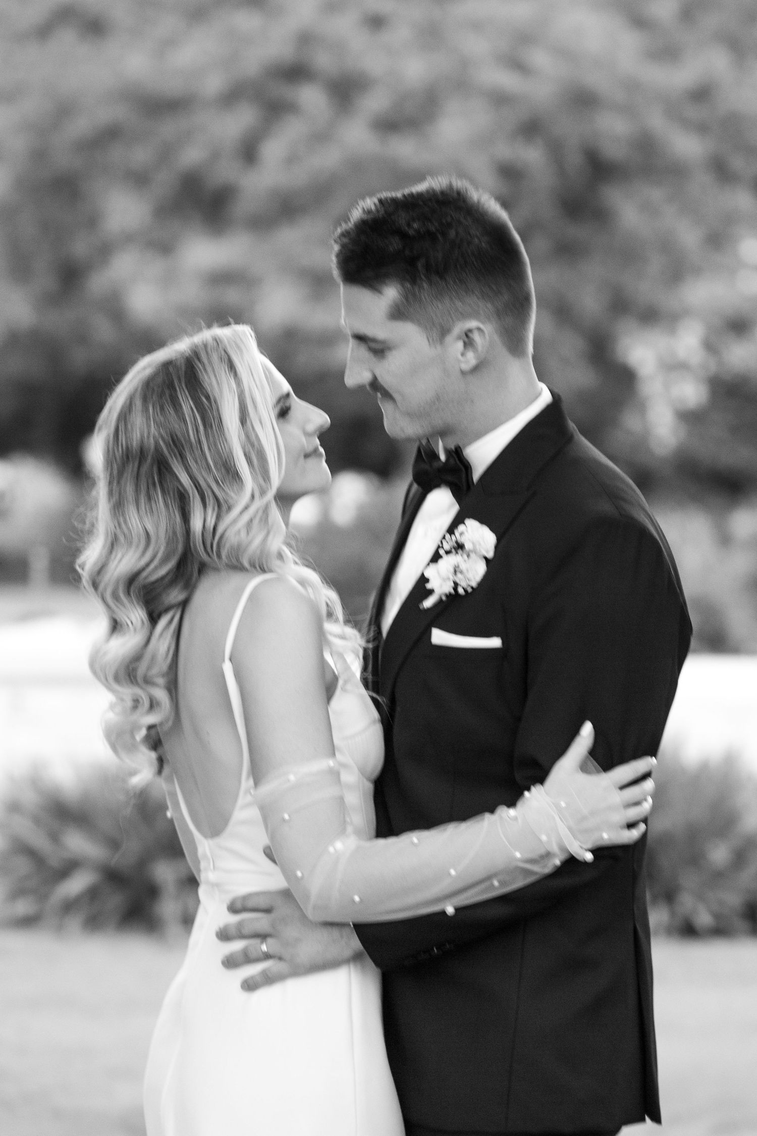 Elegant bride and groom share intimate moment during their wedding photoshoot.