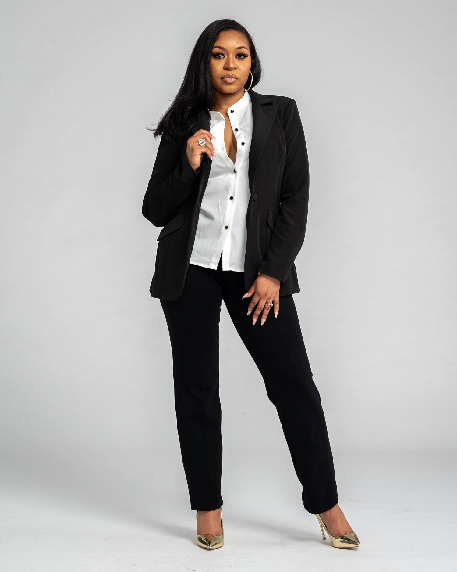 Professional studio portrait in black business suit and white shirt.