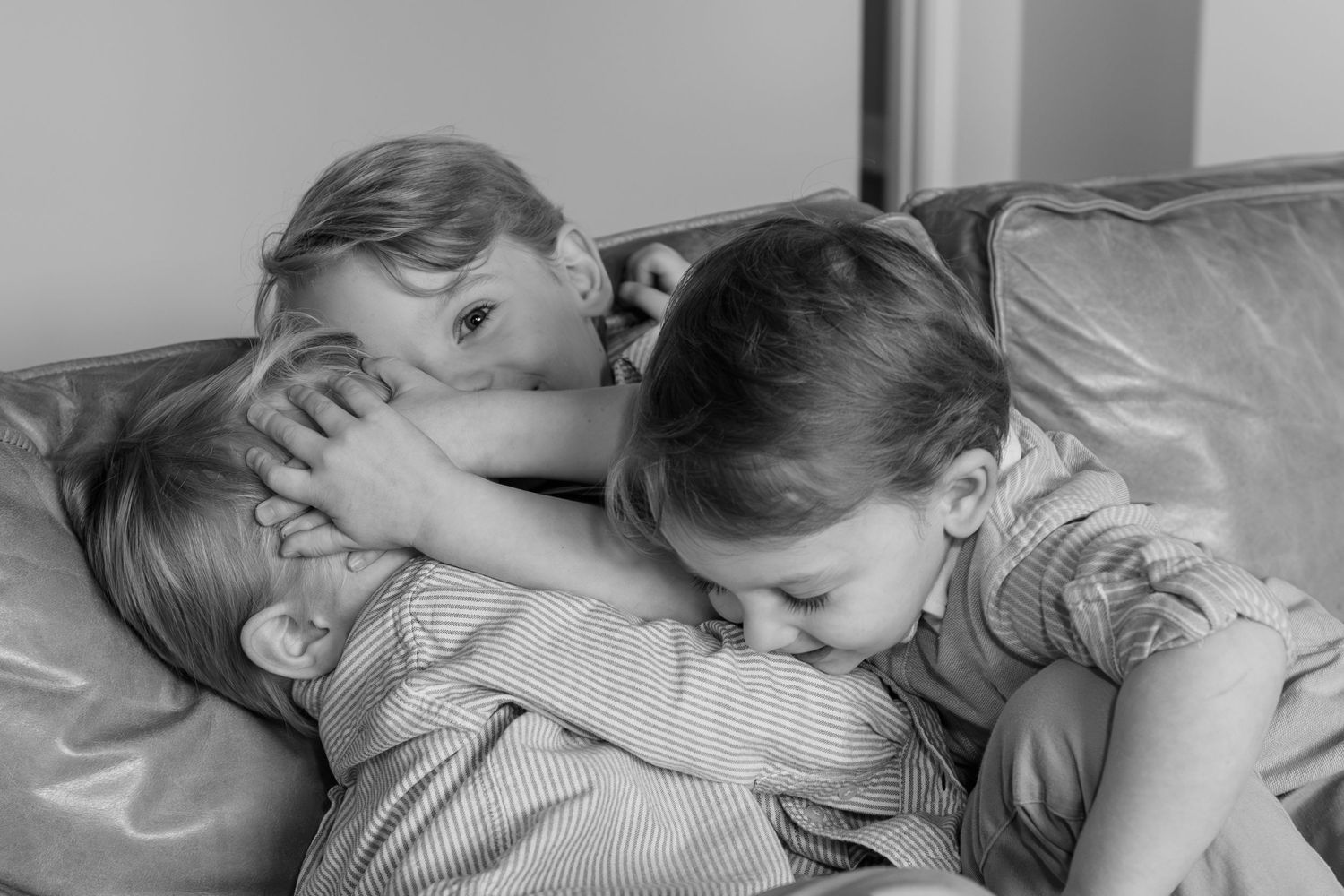 A sleeping person peacefully rests with their head on a white pillow, captured in black and white.
