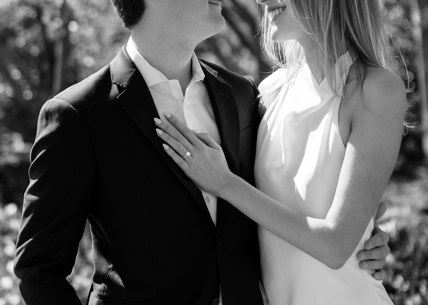 A romantic black and white wedding photo collage showing intimate moments between a bride and groom outdoors.