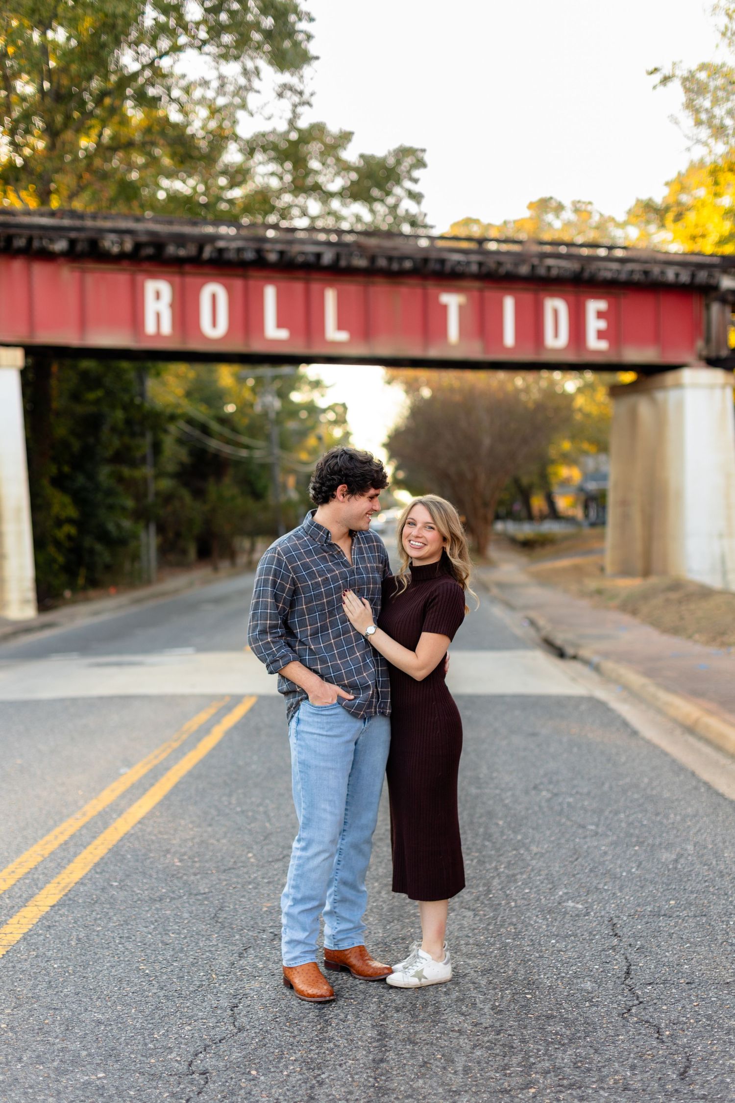 A couple shares a romantic moment on a street with 