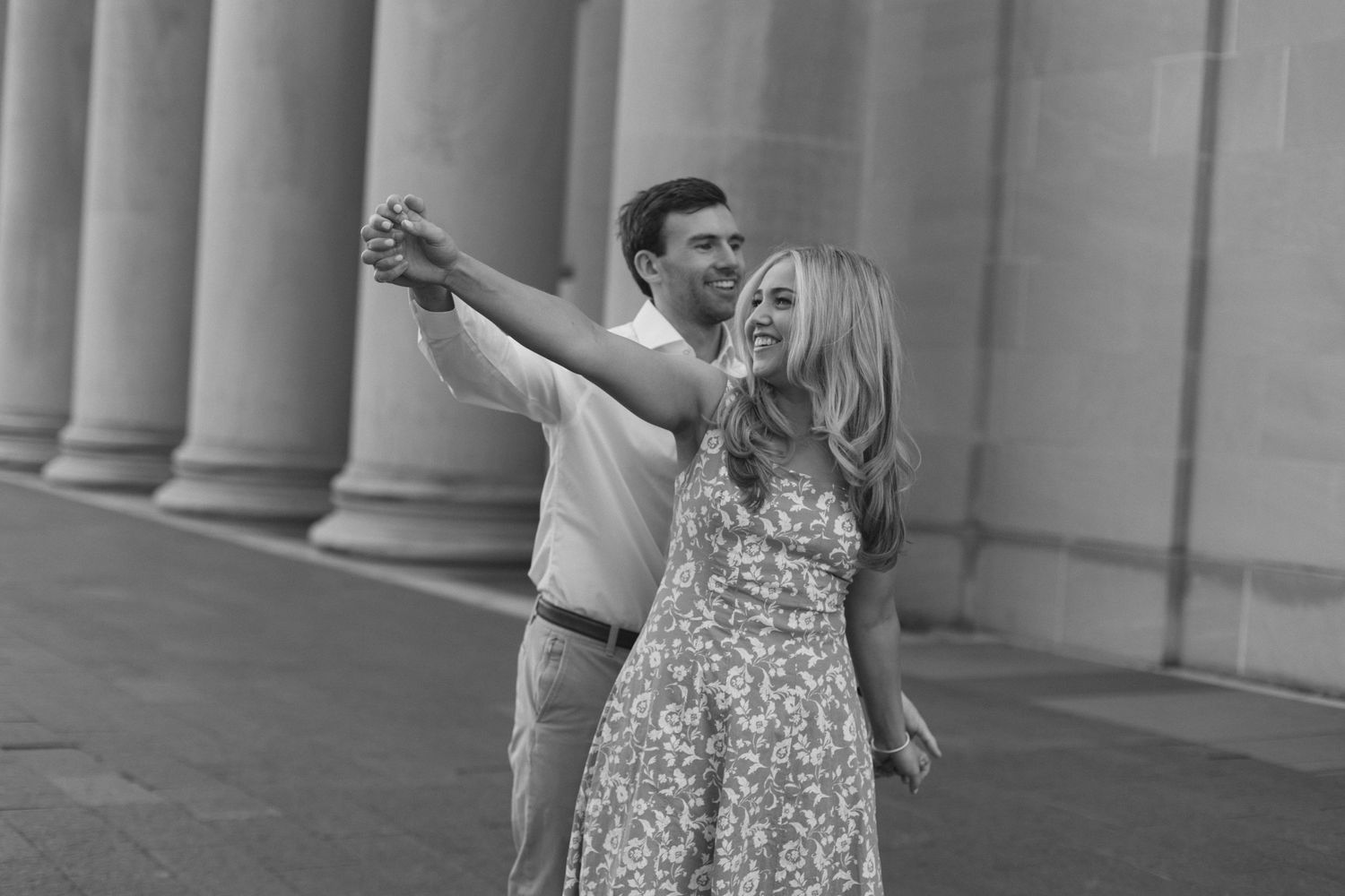 Romantic couple dancing together near classic stone columns in black and white by Hannah Rogg Taylor for epagaFOTO.
