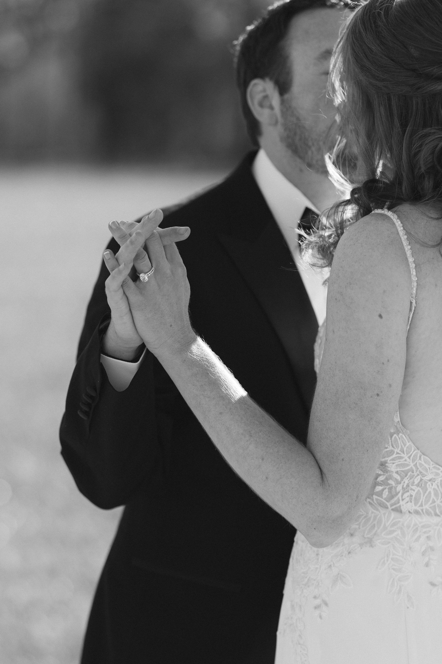 Intimate black and white photo of a couple sharing a close dance moment at their wedding.