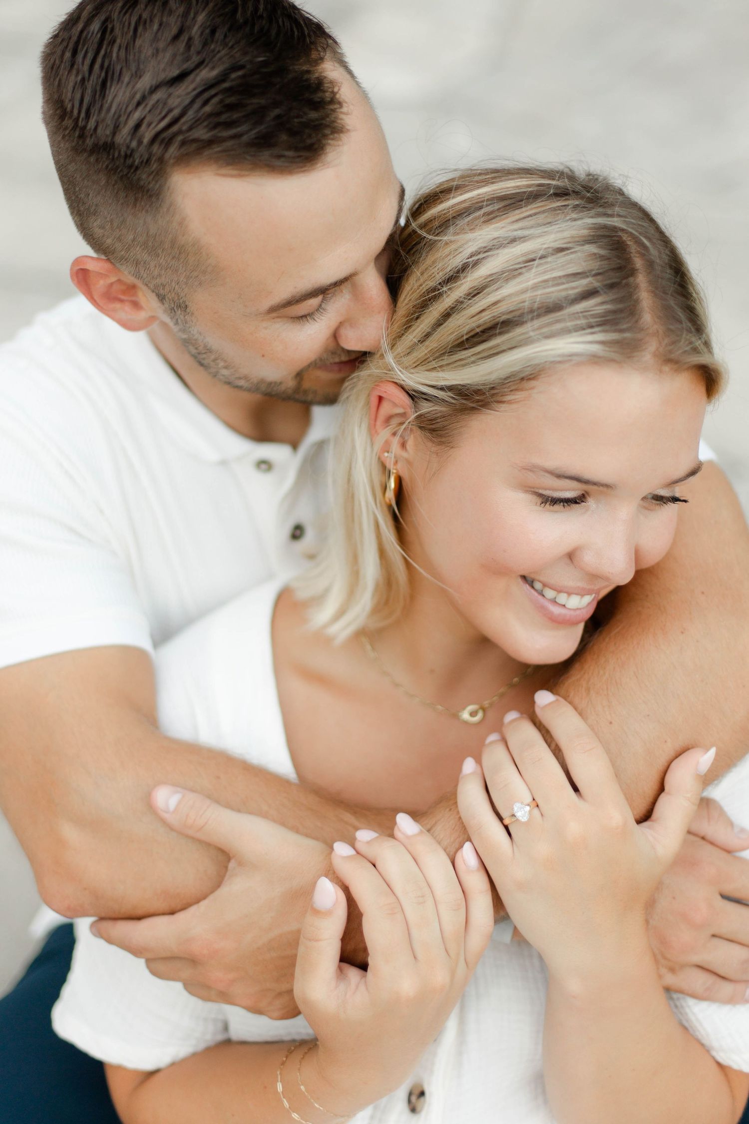 Intimate close-up of couple sharing tender moment in casual white attire. Wedding photographer Hannah Rogg Taylor