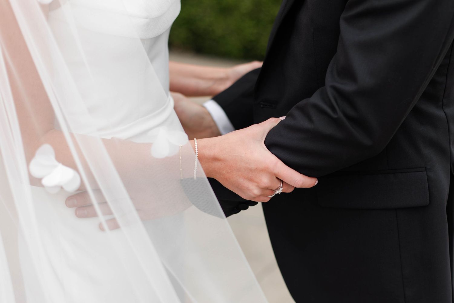 Close-up of hands holding rings during a wedding ceremony at Mission Hills Country Club in Kansas City..